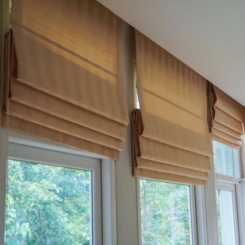 Folded fabric roman blinds over a window