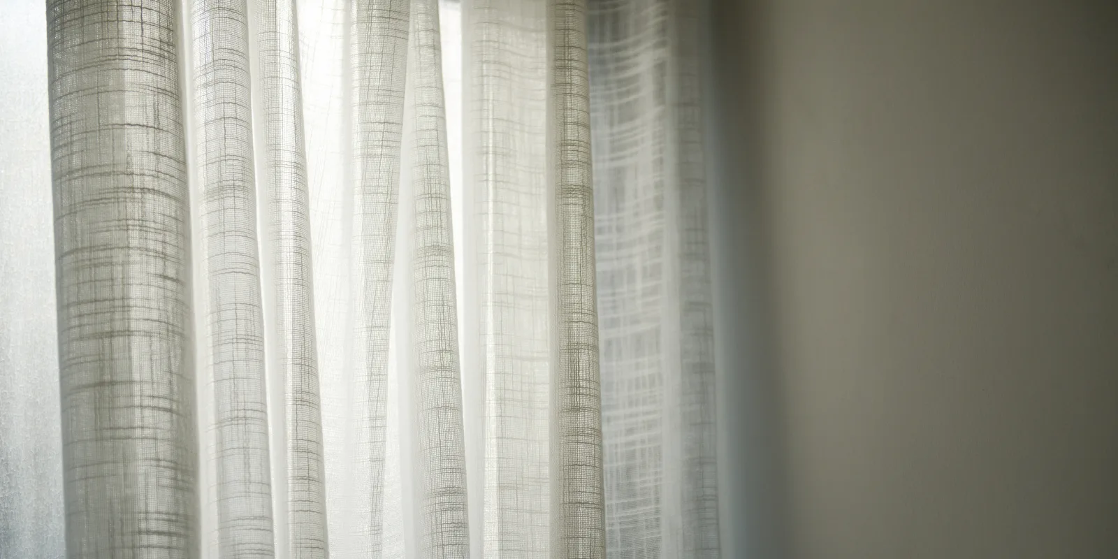 Soft white sheer curtains filtering daylight