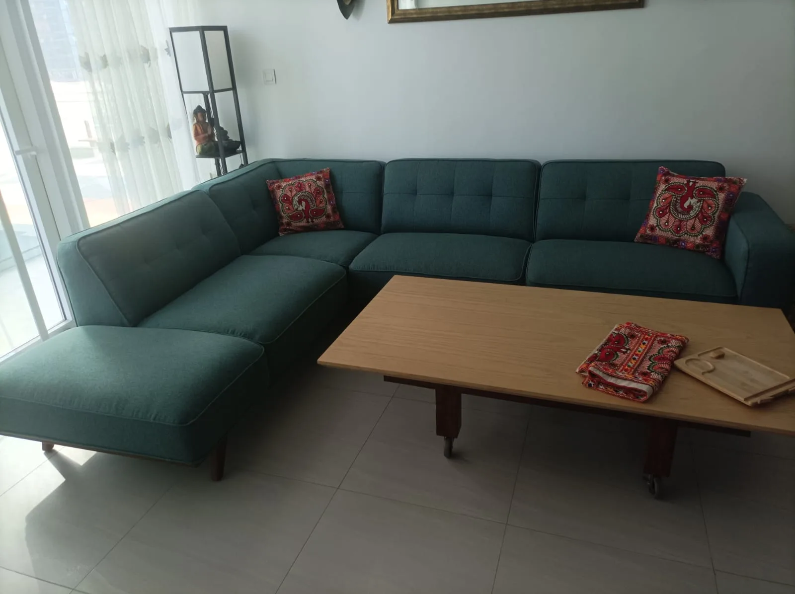 A custom sectional sofa upholstered in teal fabric