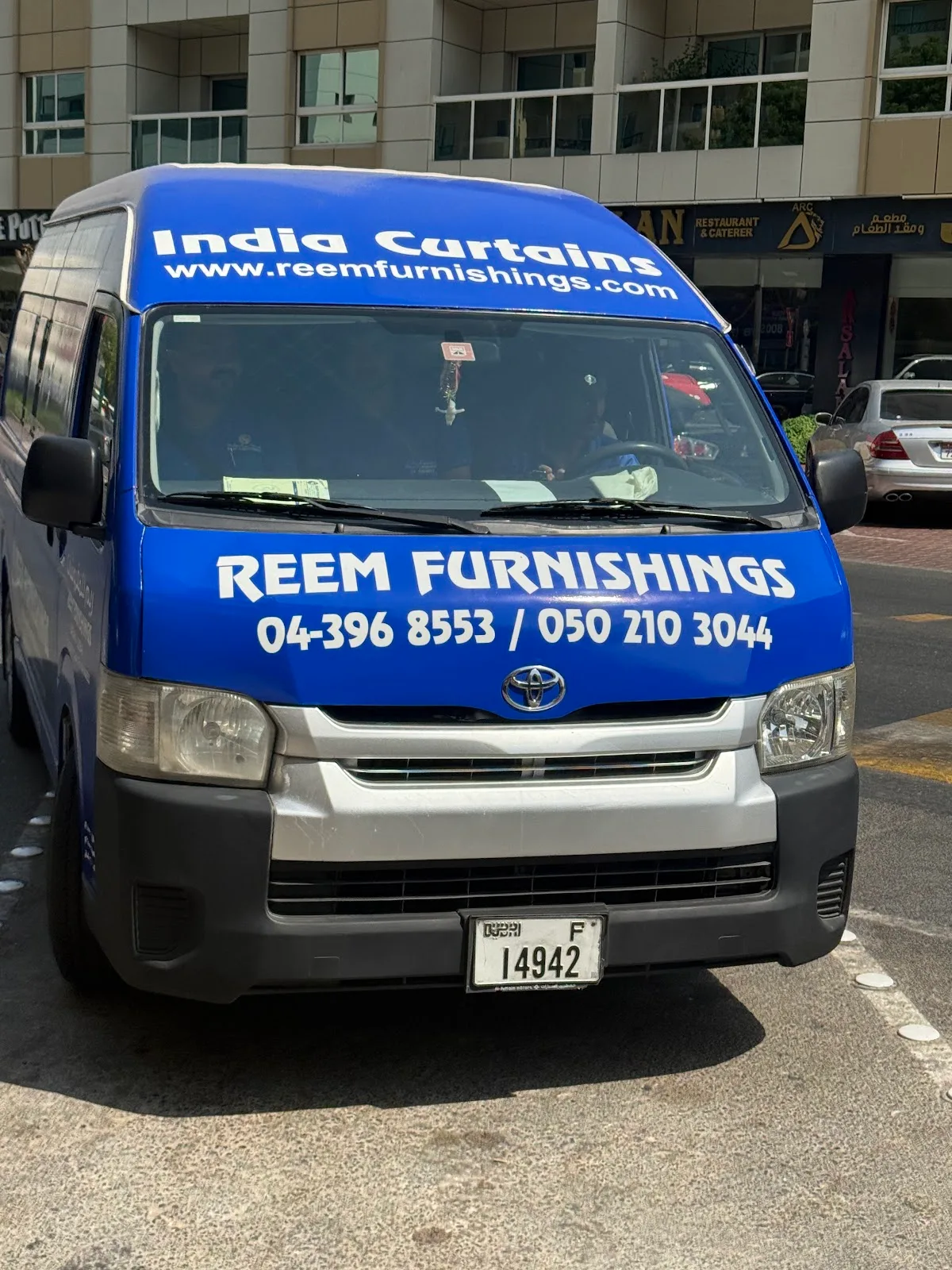 The Reem Furnishings delivery van on a Dubai street