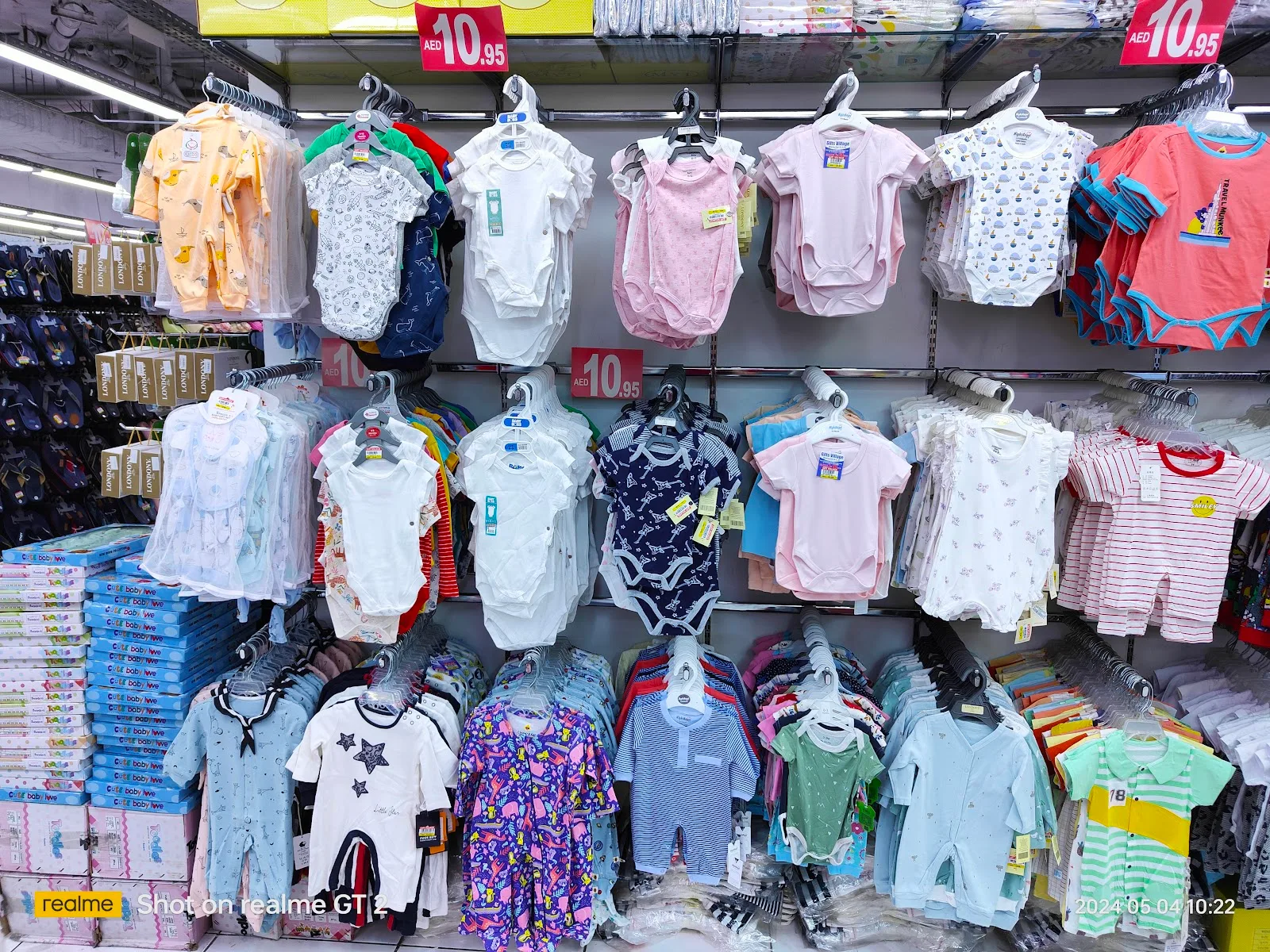 Display of baby bodysuits, rompers and kidswear on hangers at Gifts Village
