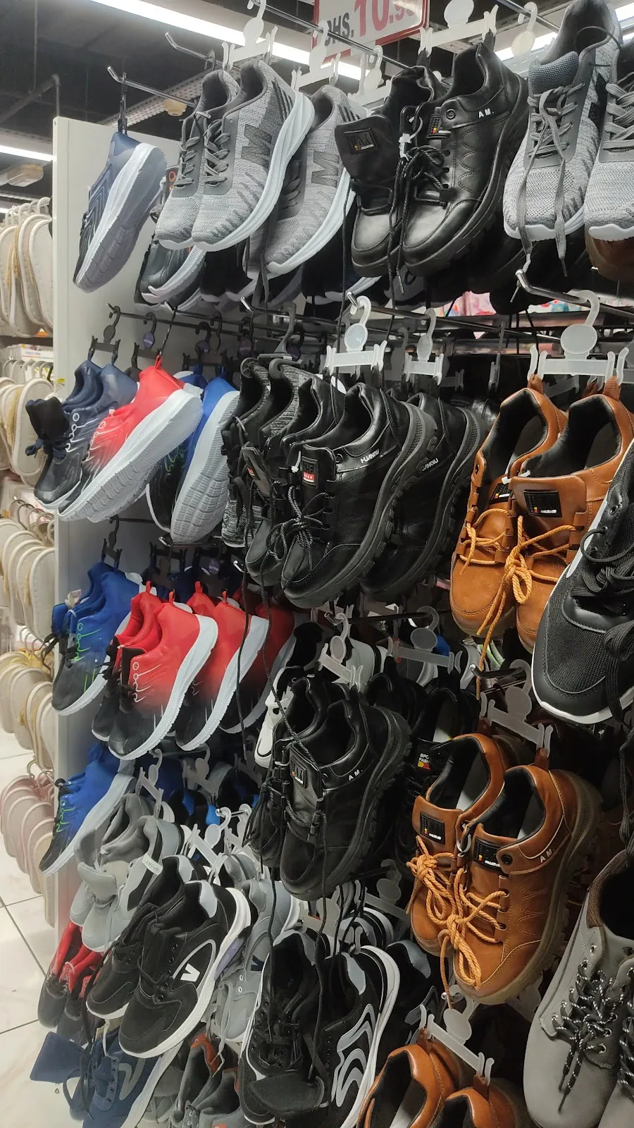 Racks of sneakers, sandals and shoes for all ages at Gifts Village