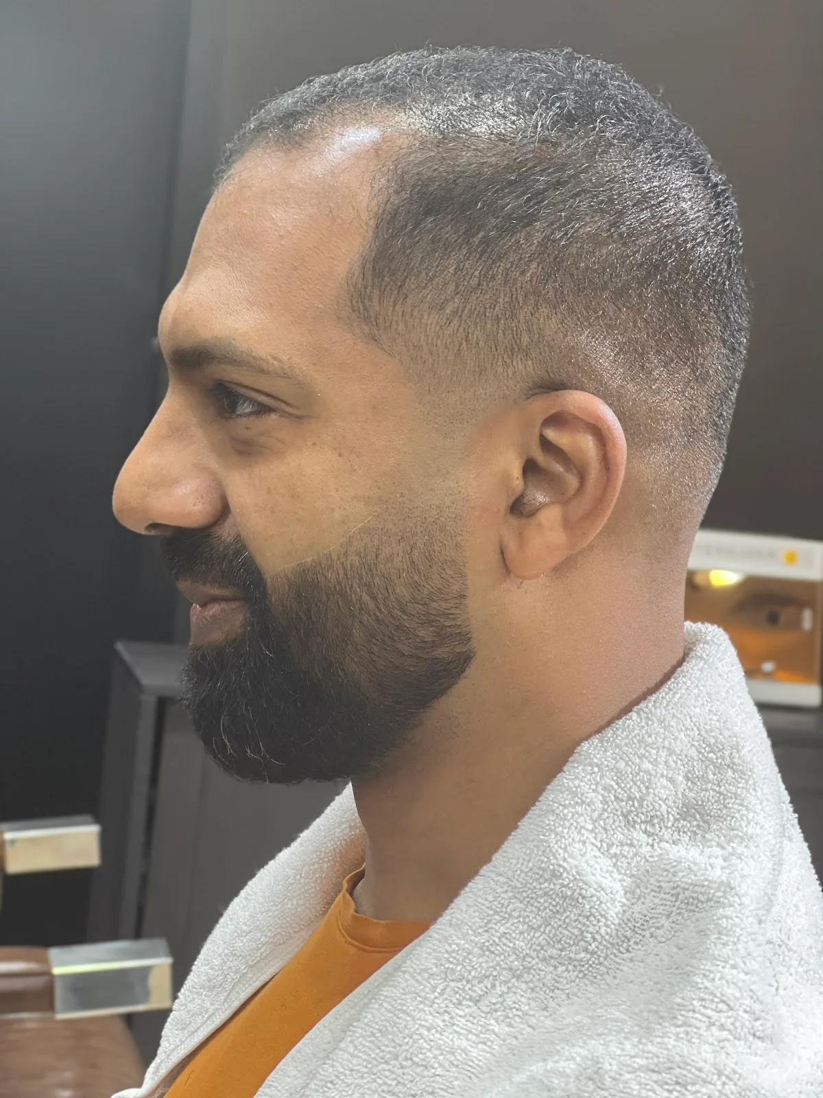 Skin fade and sculpted beard, side profile