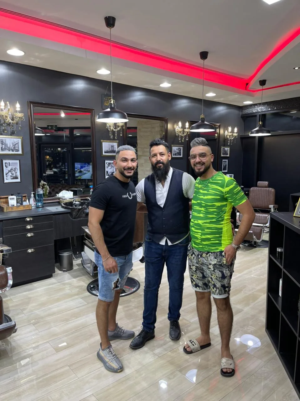 Happy clients and barbers together at the shop