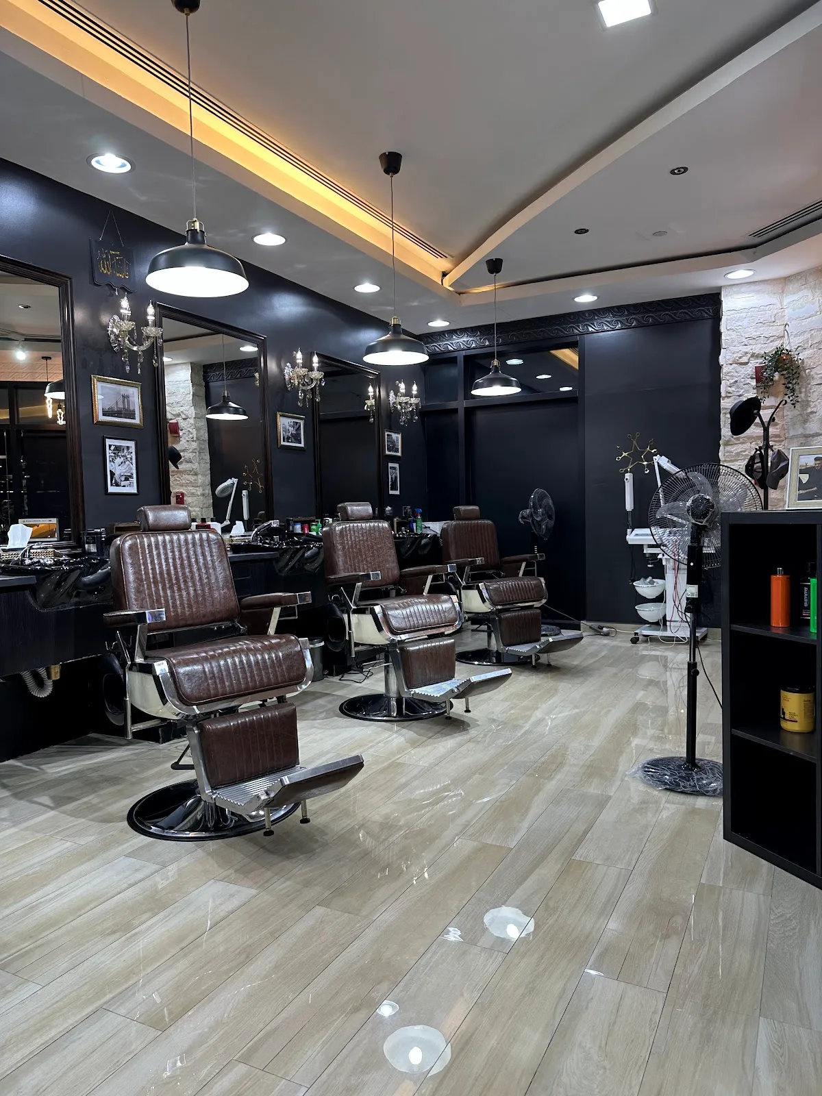 Leather barber chairs and lit mirrors inside the shop