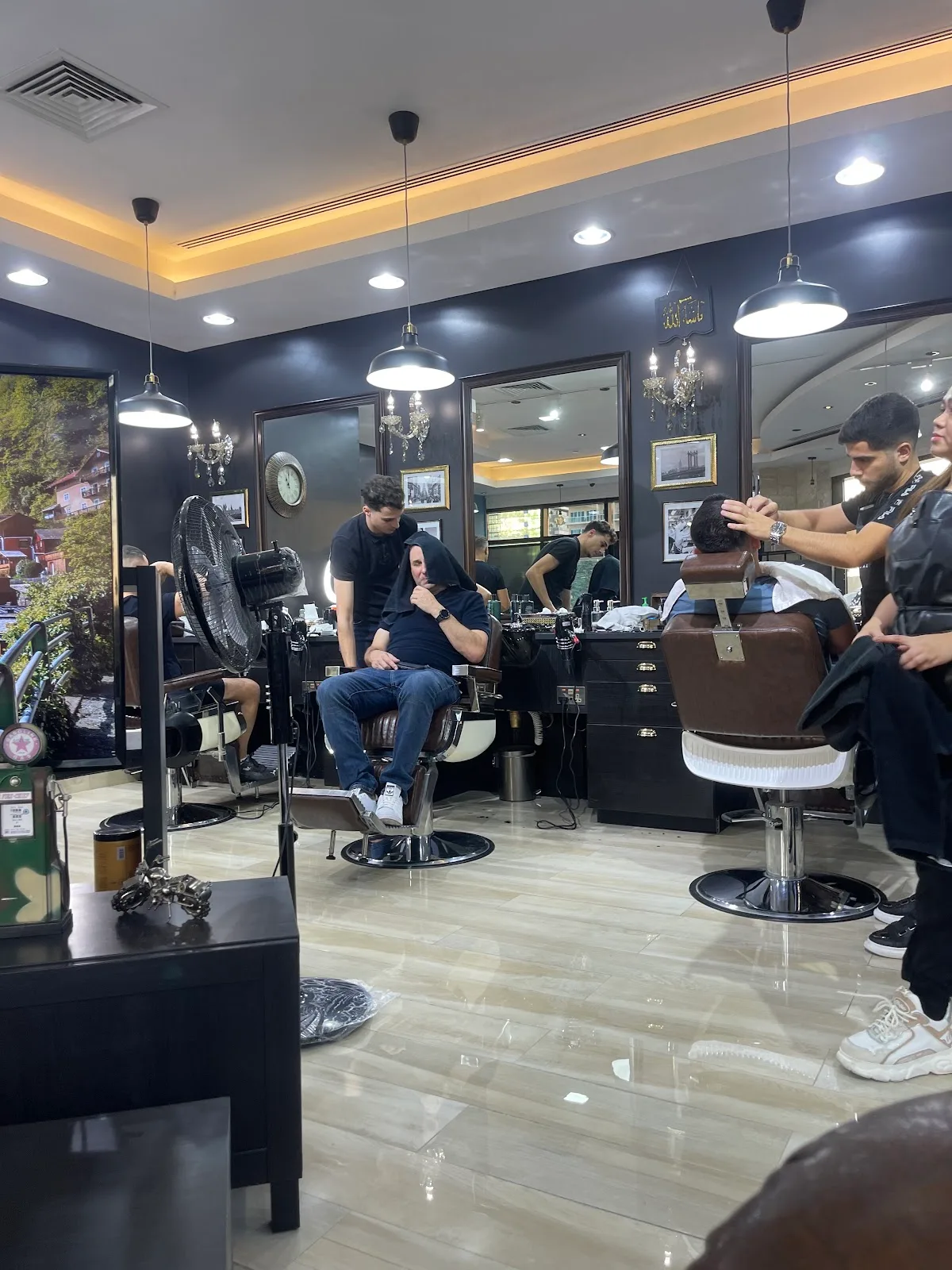 Barbers working with clients at James Pro Barbers