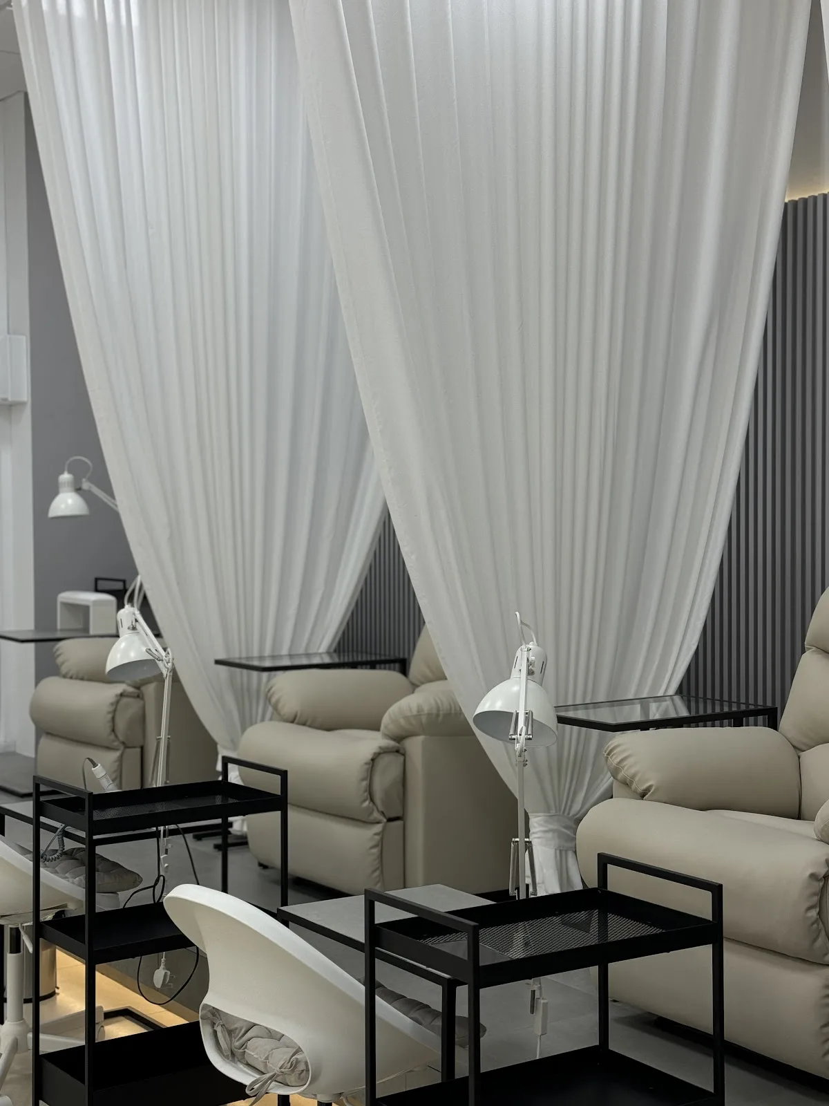 Unique You Al Barsha pedicure lounge with cream chairs and white drapes