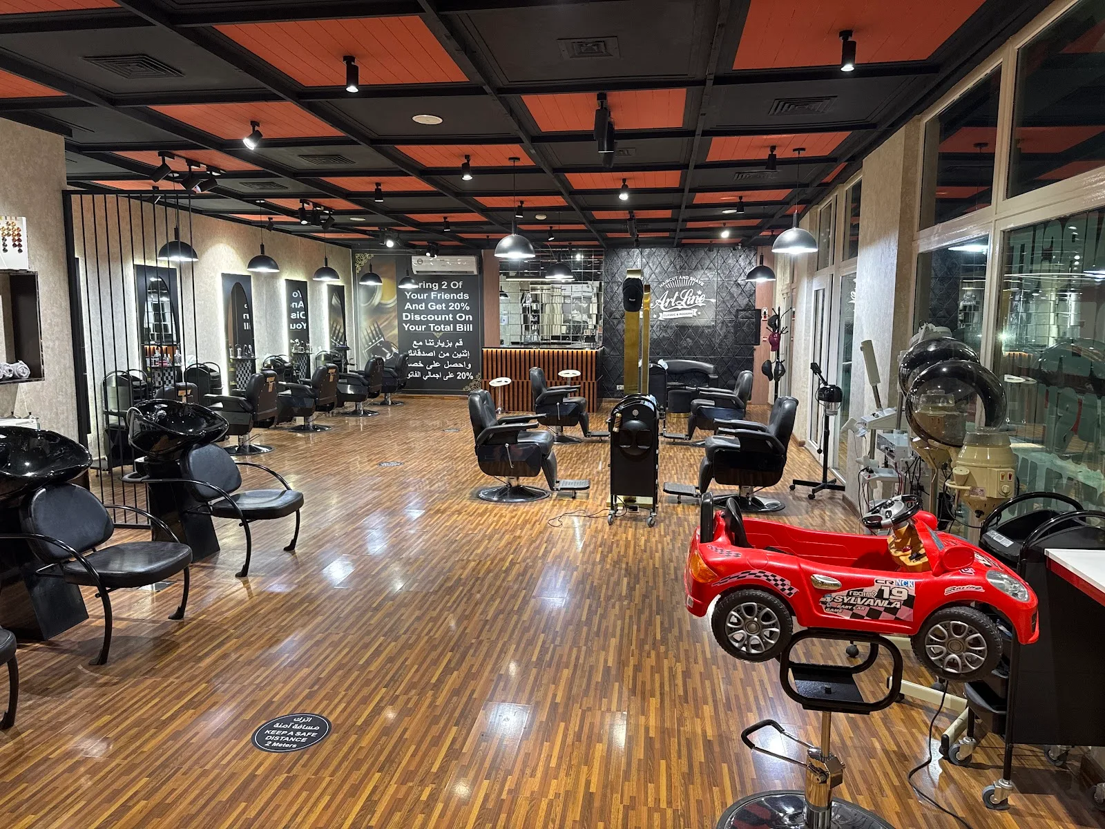 Interior of ArtLine Gents Salon with styling chairs and wood floor
