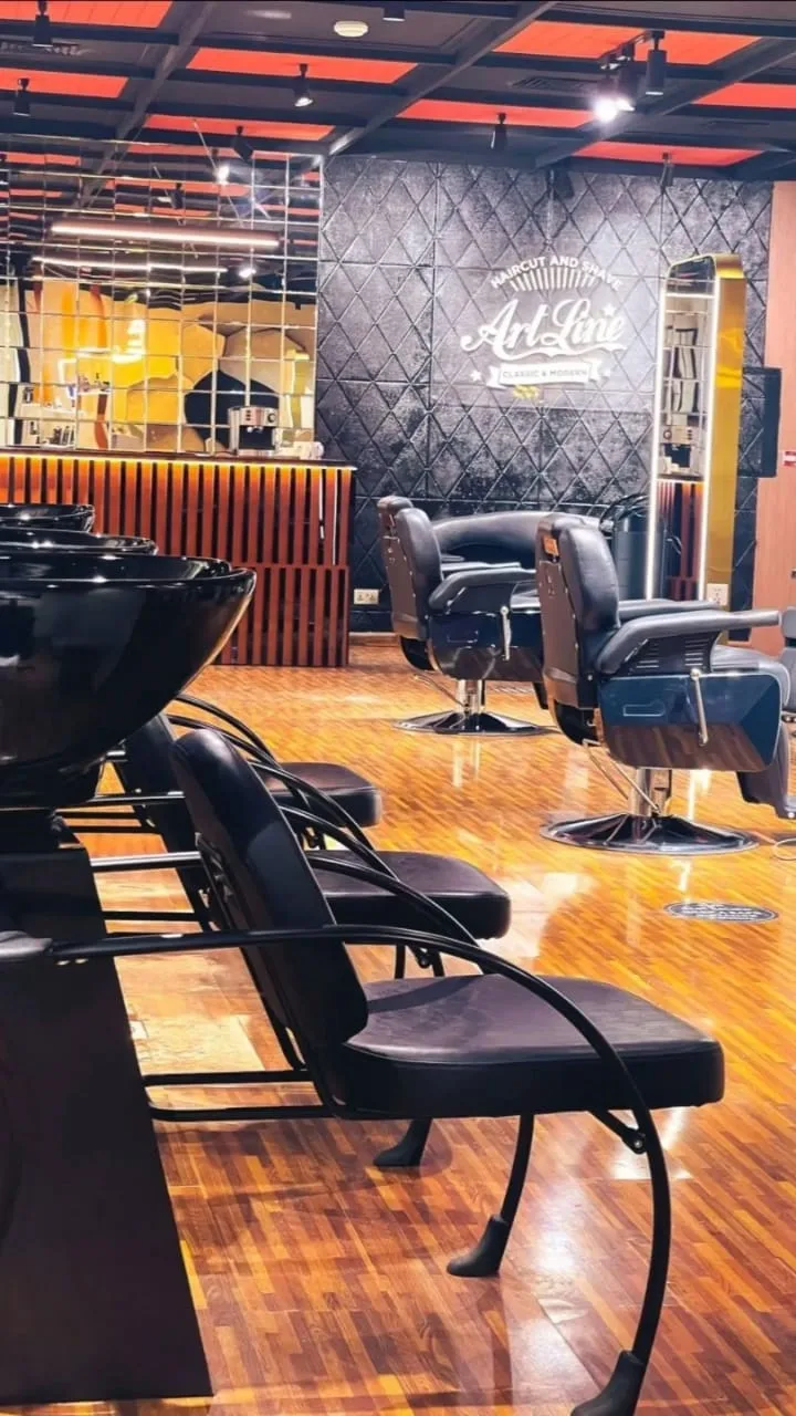 Row of wash chairs under the ArtLine logo wall