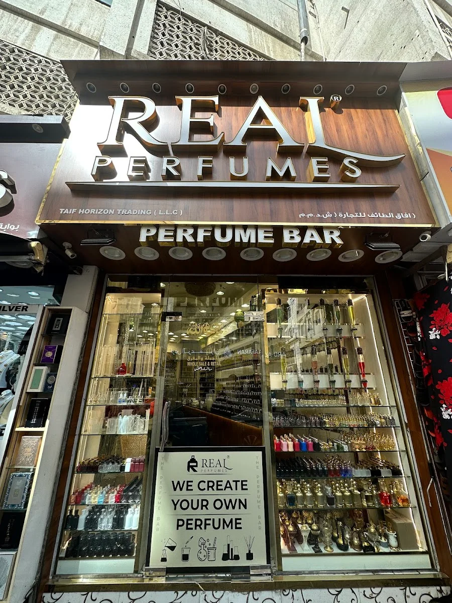 The Real Perfumes The Perfume Bar storefront in Deira with its wooden sign and a window full of bottles