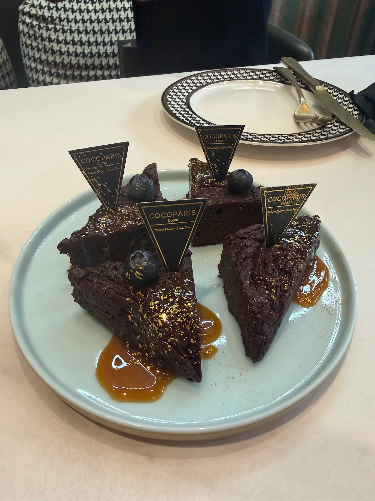 Chocolate cake slices with COCOPARIS flags and gold dust