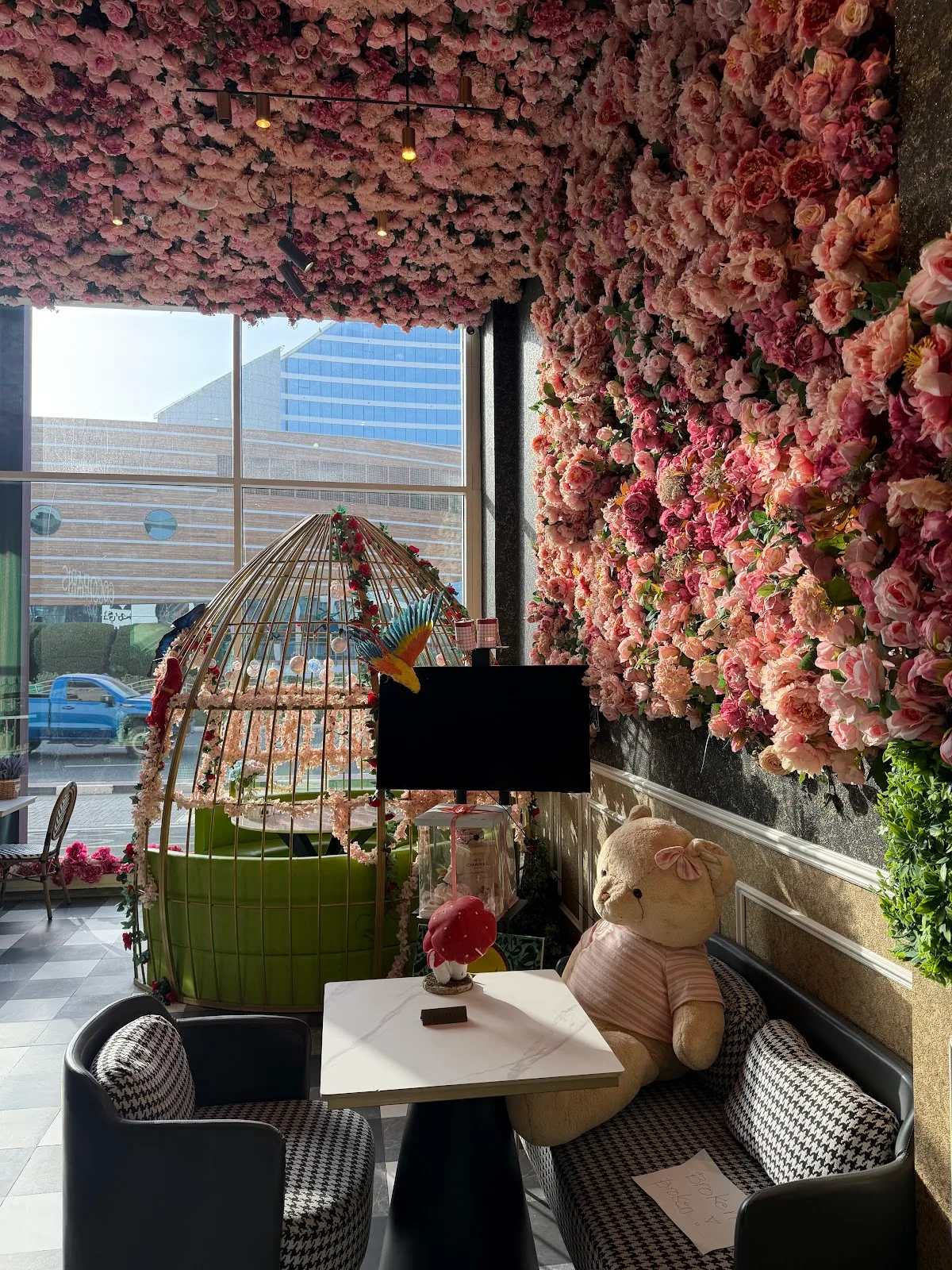 Pink flower wall with gold birdcage seating