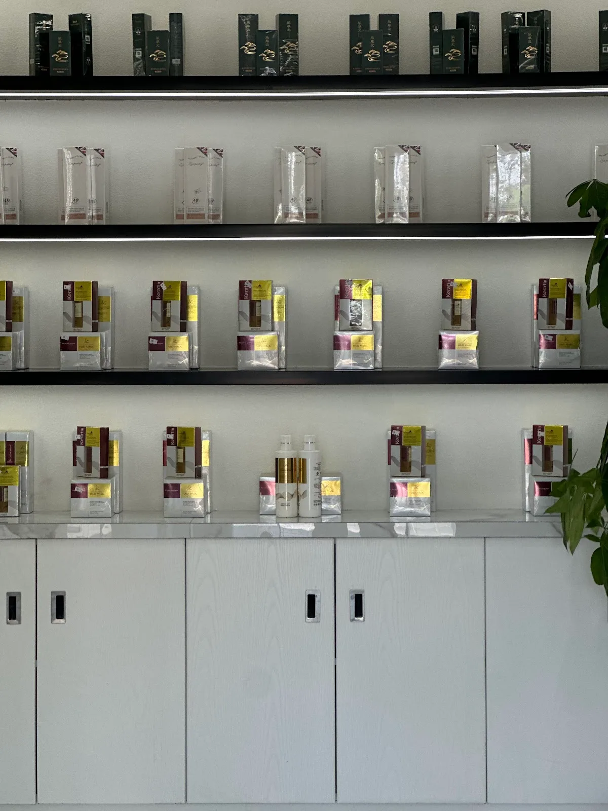 Shelves of keratin and hair-care products at the studio