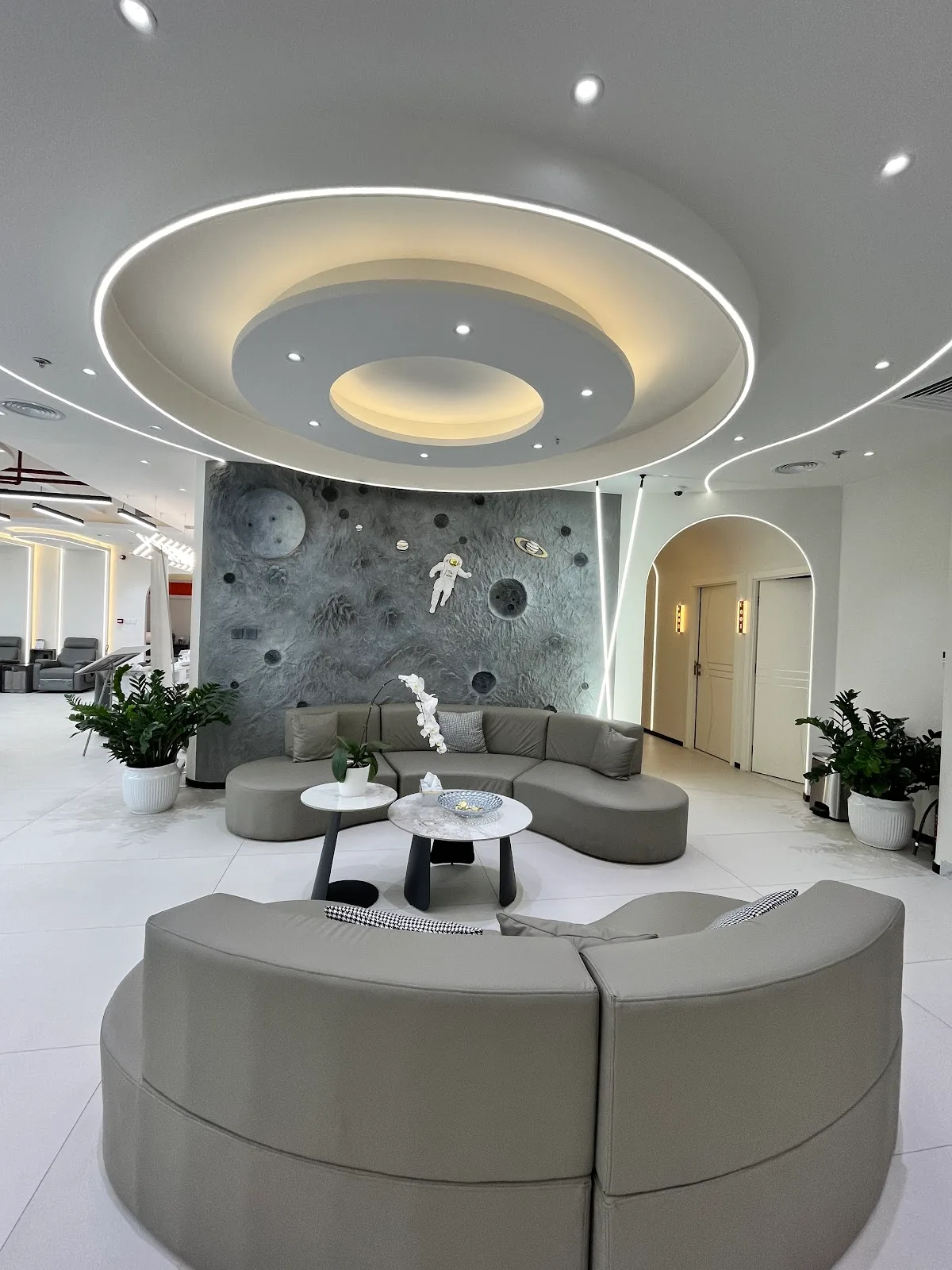 Wide view of the space-themed lounge with circular lighting