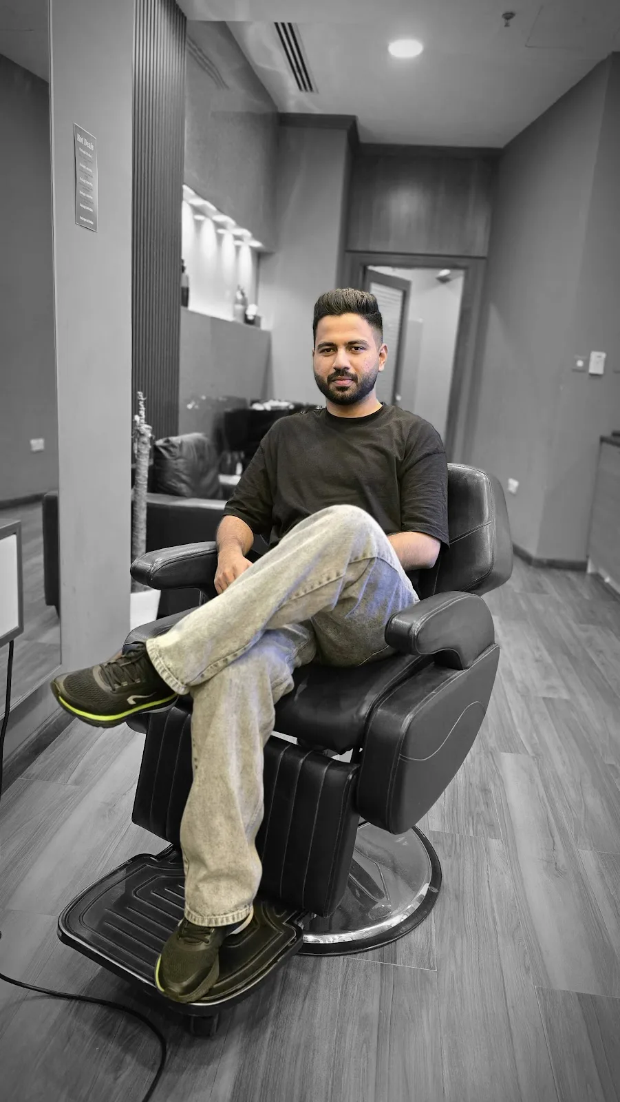 Client relaxing in a barber chair after a haircut at Facelook