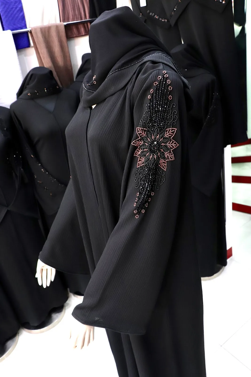 Black abaya sleeve with pink and black floral beadwork