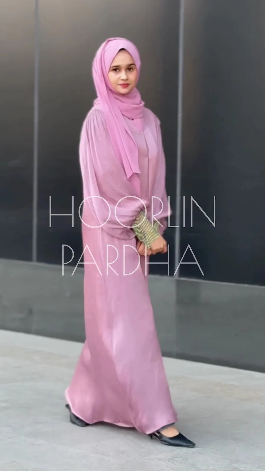 Model in a rose pink satin abaya