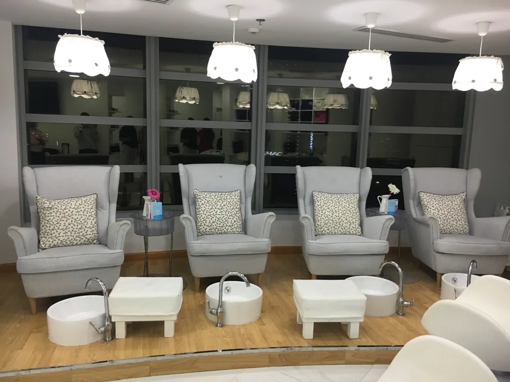 Pedicure lounge with soft grey wing chairs at Copacabana