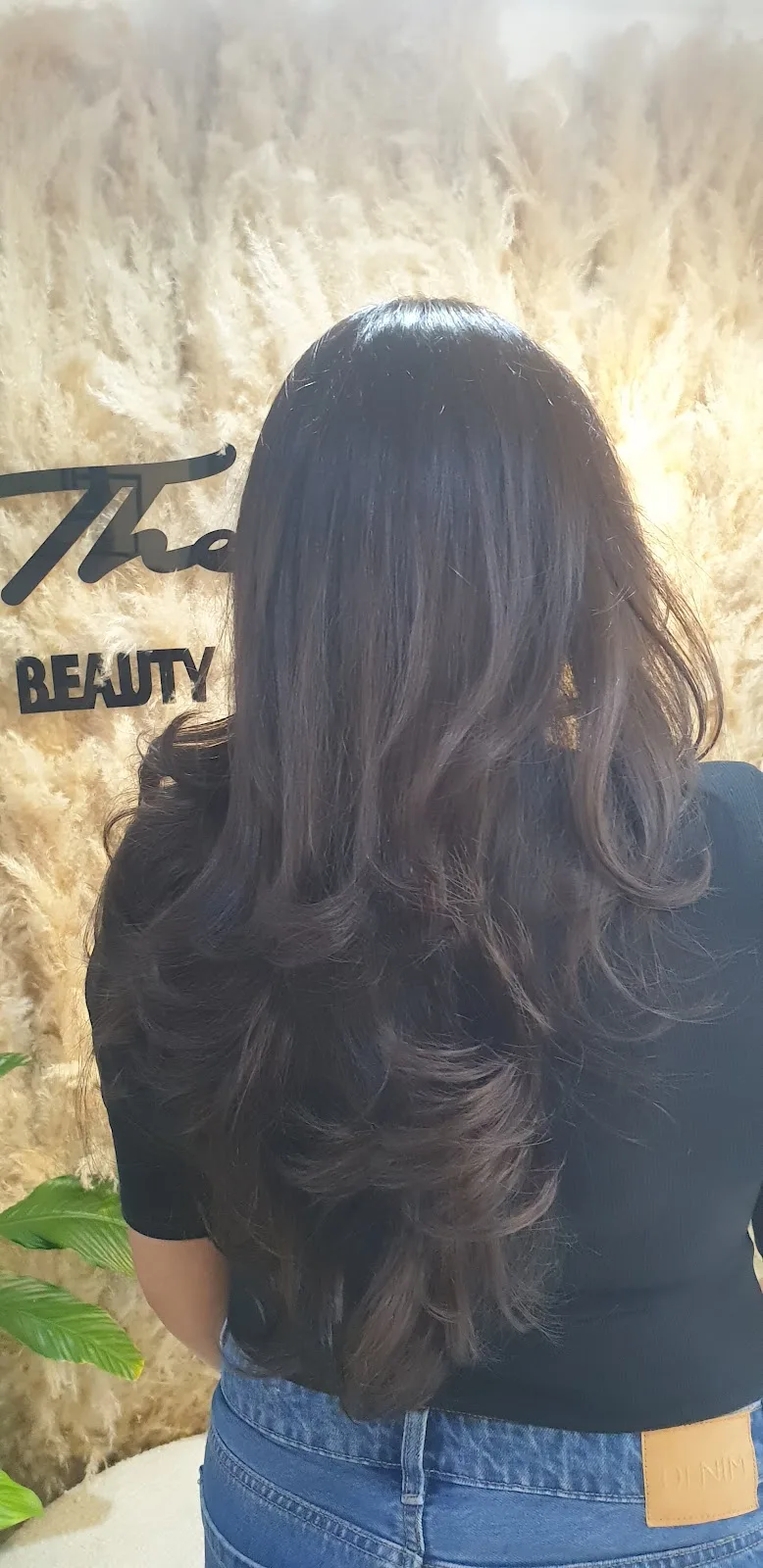 Voluminous brunette blowout at The S branded wall