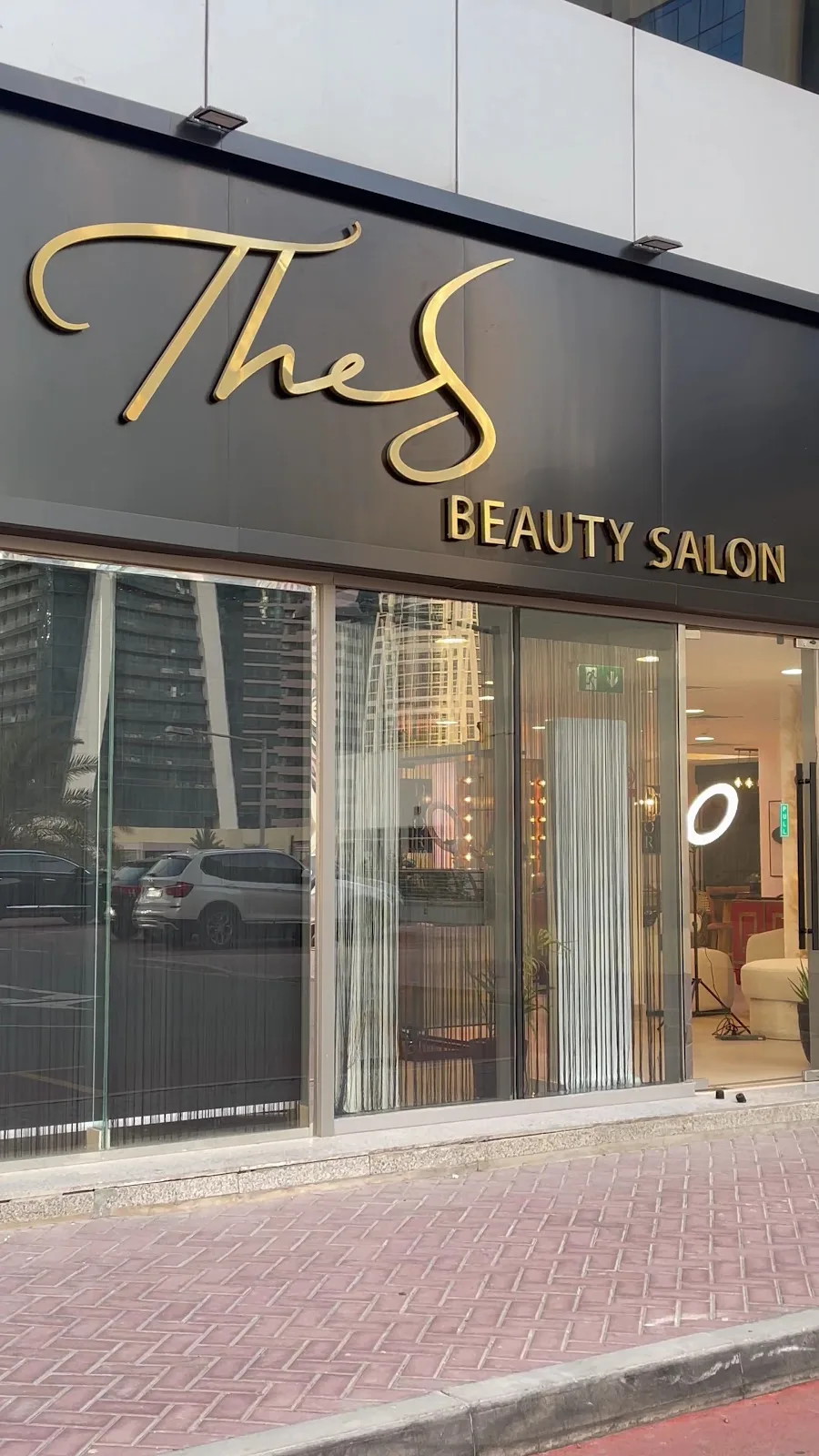 Gold storefront sign of The S Beauty Salon