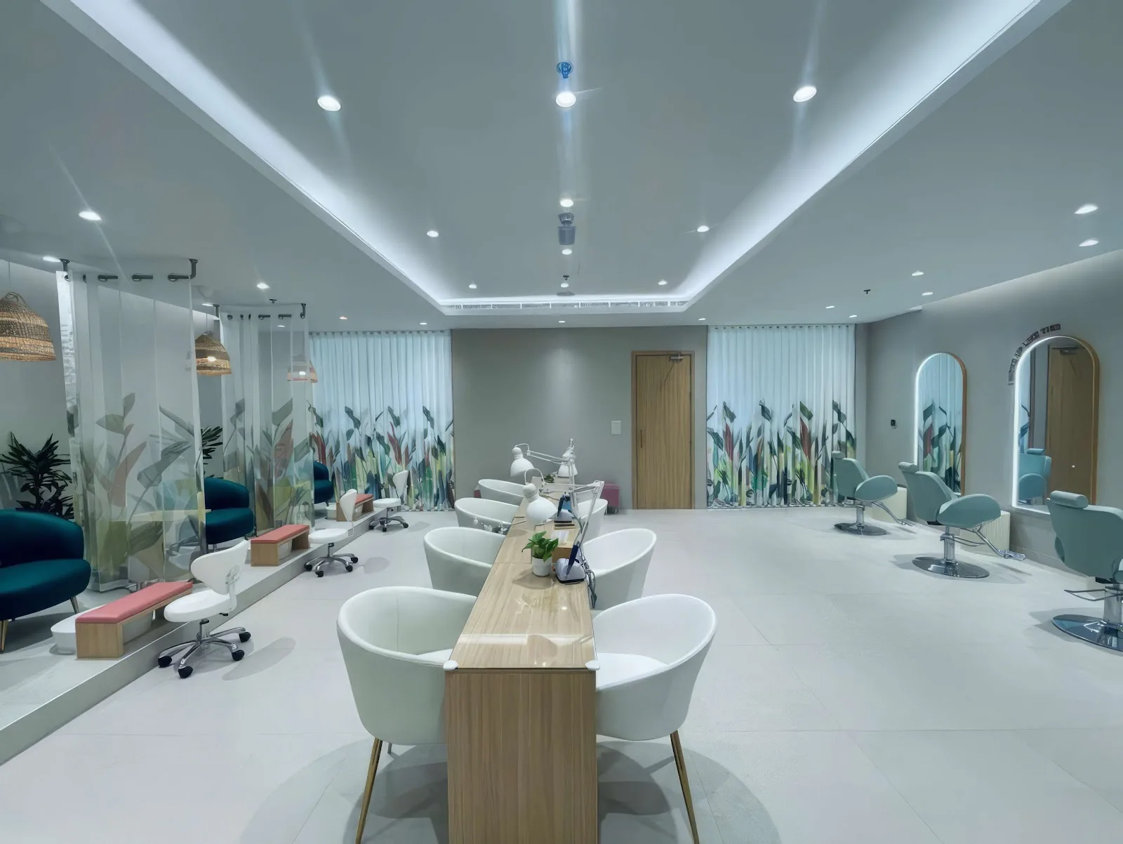 Wide view of the SHE Beauty Salon interior with manicure stations and botanical panels