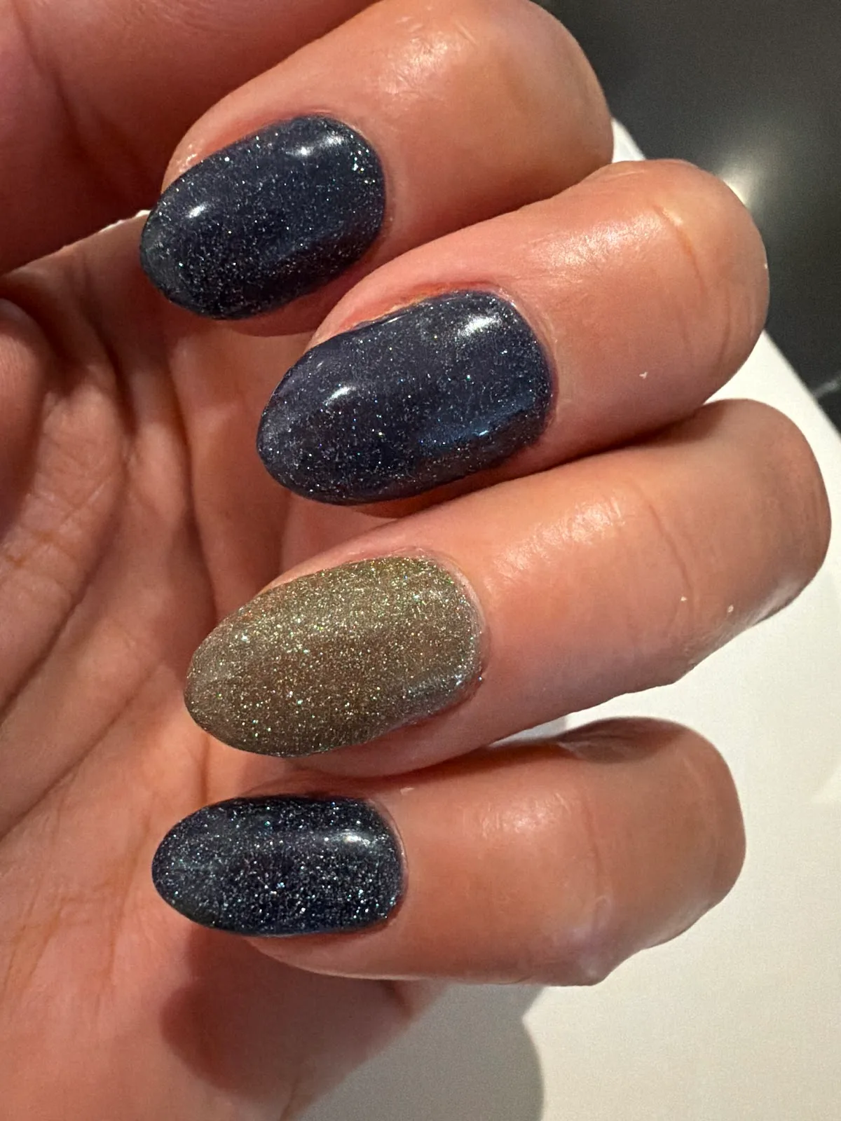 Navy and gold shimmer oval nails