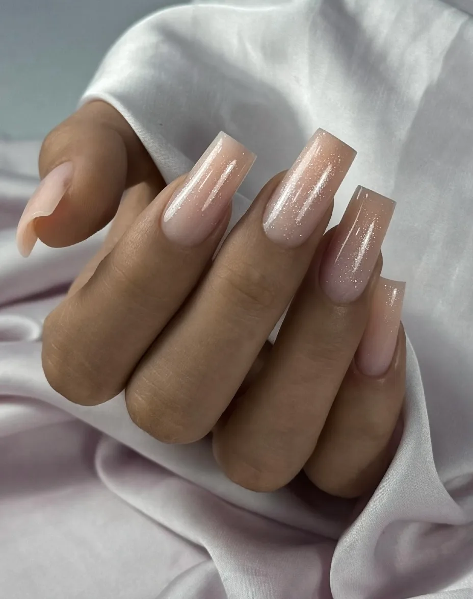 Long nude nails with a fine shimmer on silk