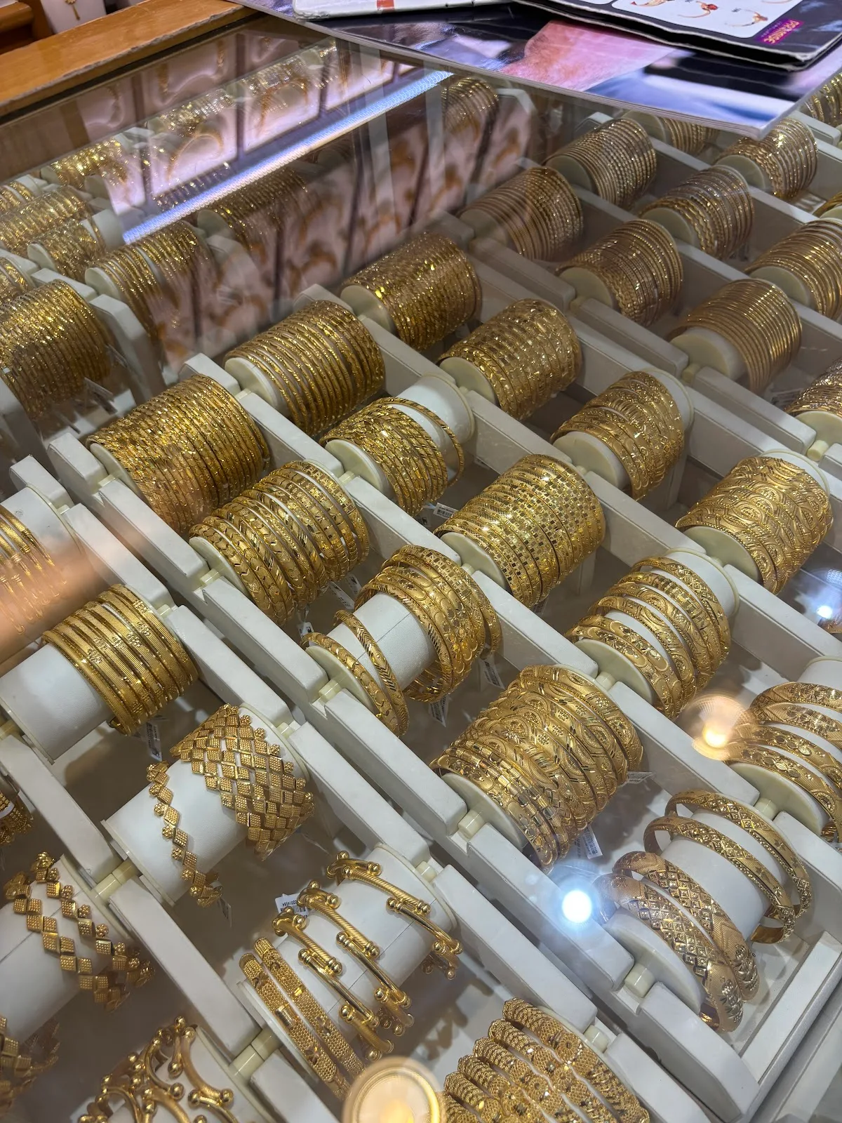 Trays of intricately patterned gold bangles