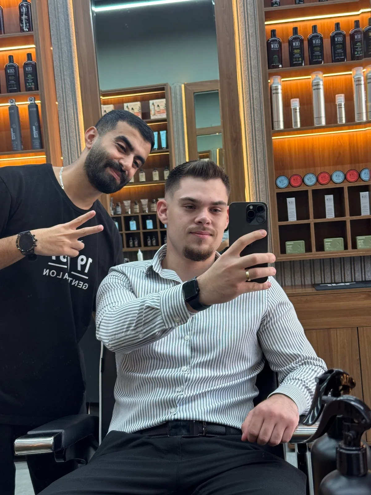 Client and barber in the mirror after a fresh cut