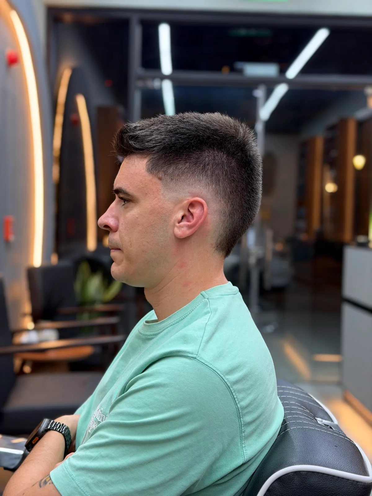 Clean skin fade tapering into short textured hair on top