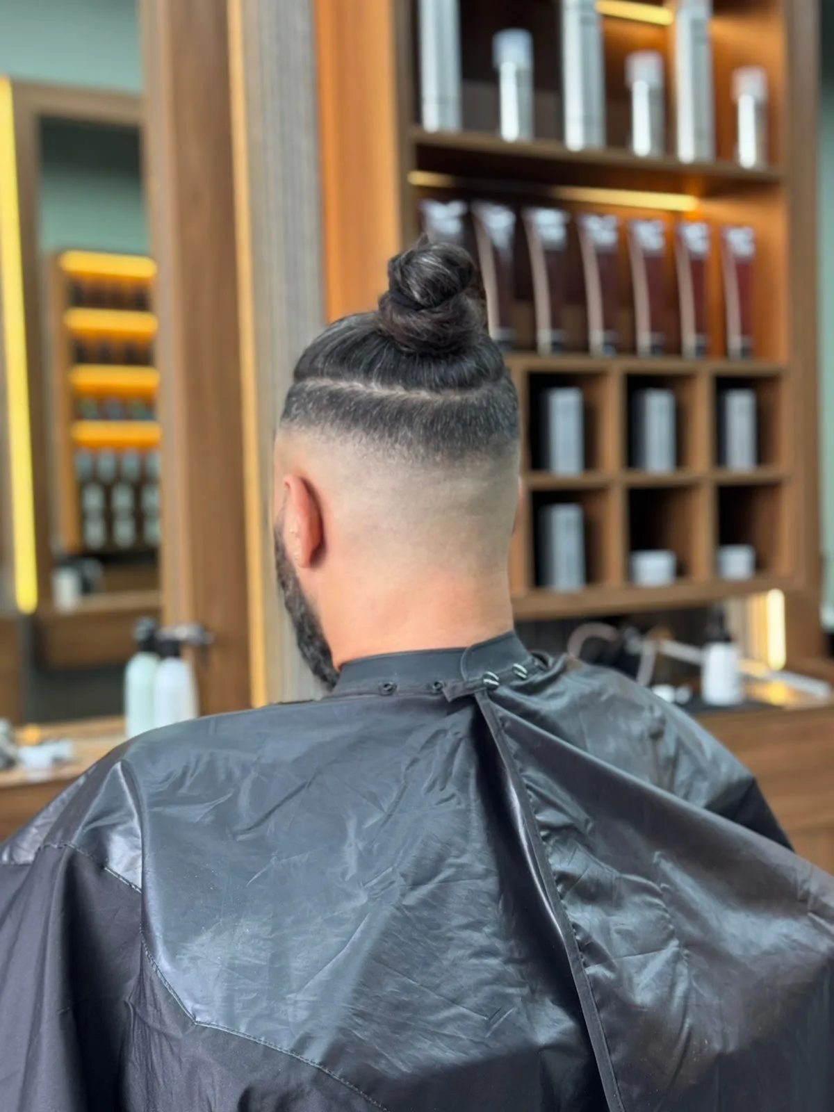Top-knot with a sharp drop fade on the back and sides