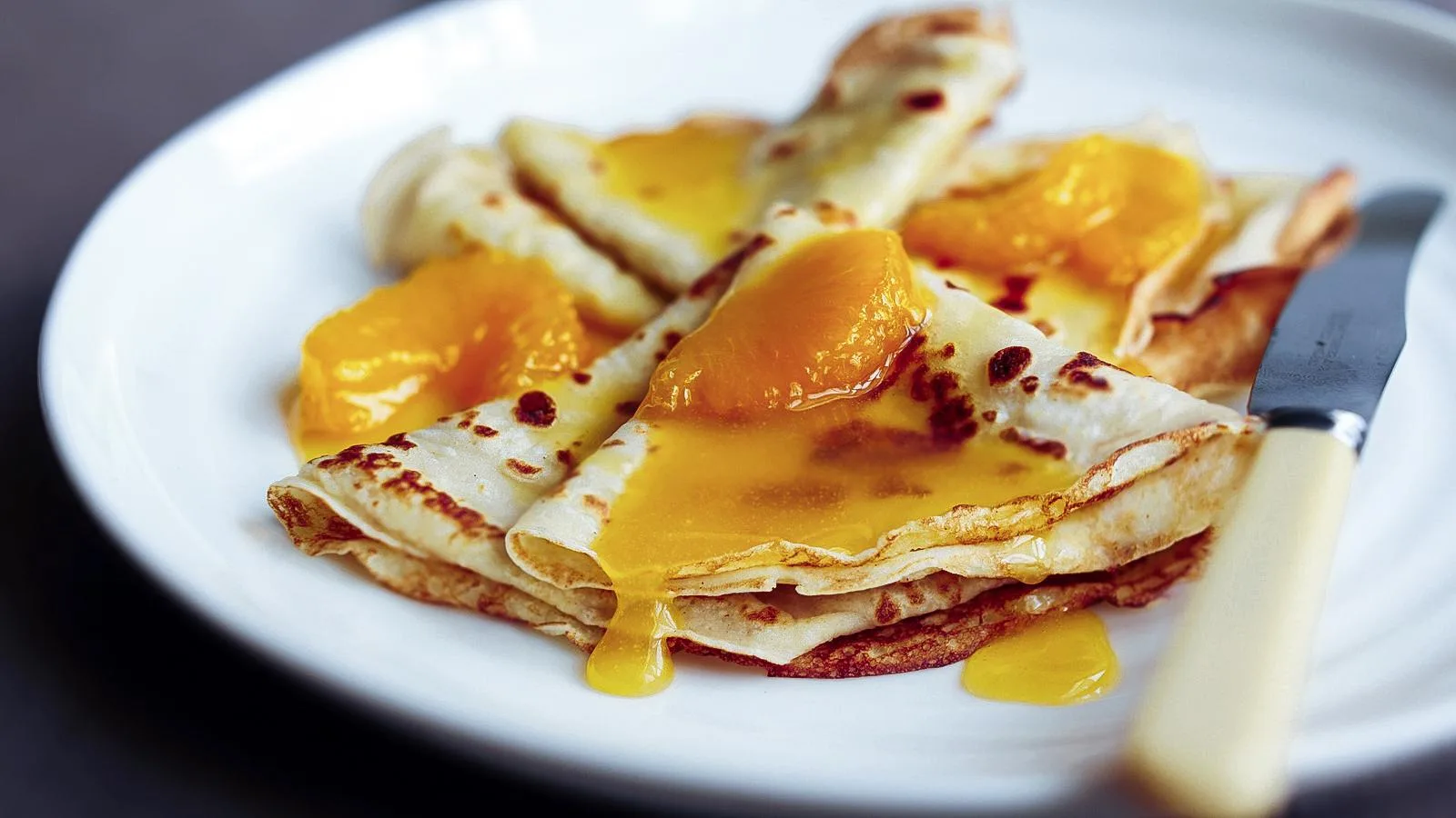 Crêpes with orange segments and citrus glaze