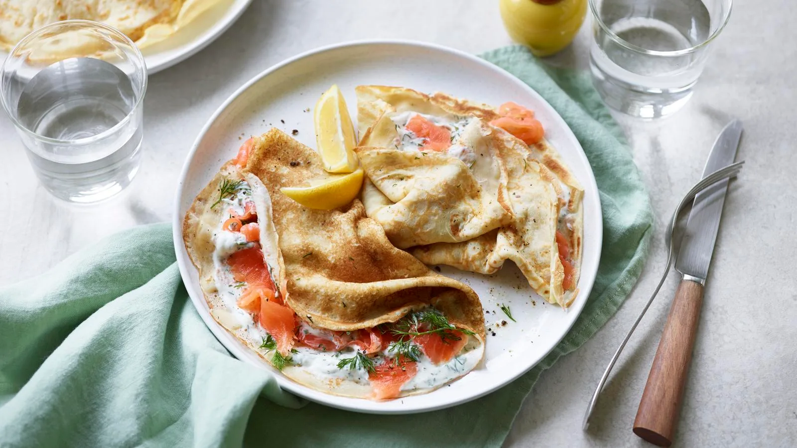 Savoury crêpes filled with smoked salmon, dill and cream