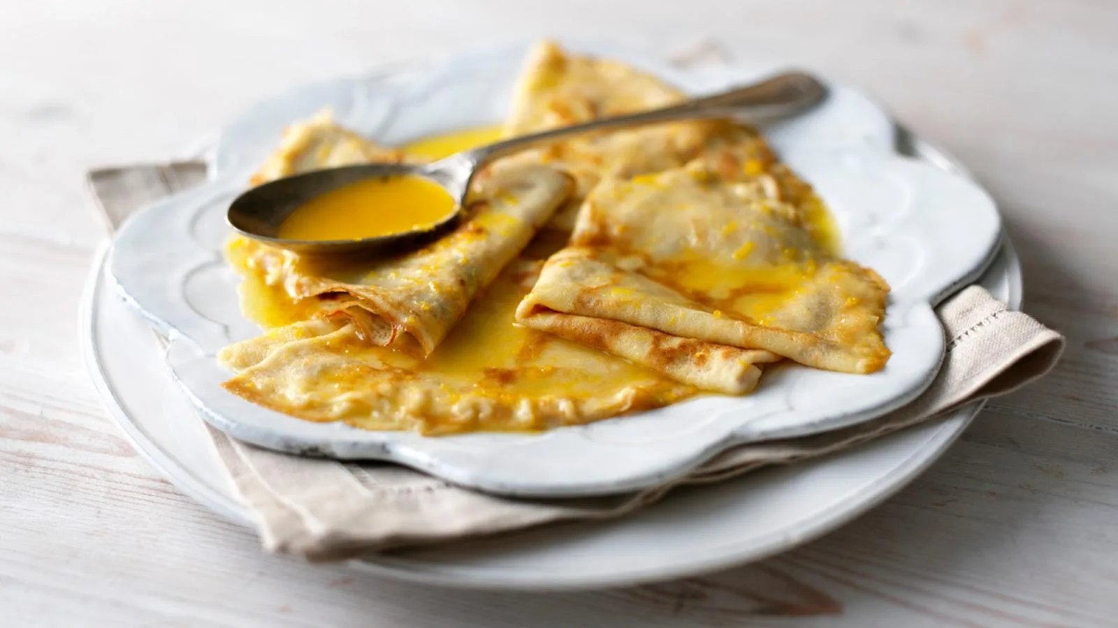 Folded sweet crêpes glazed with warm orange-butter sauce