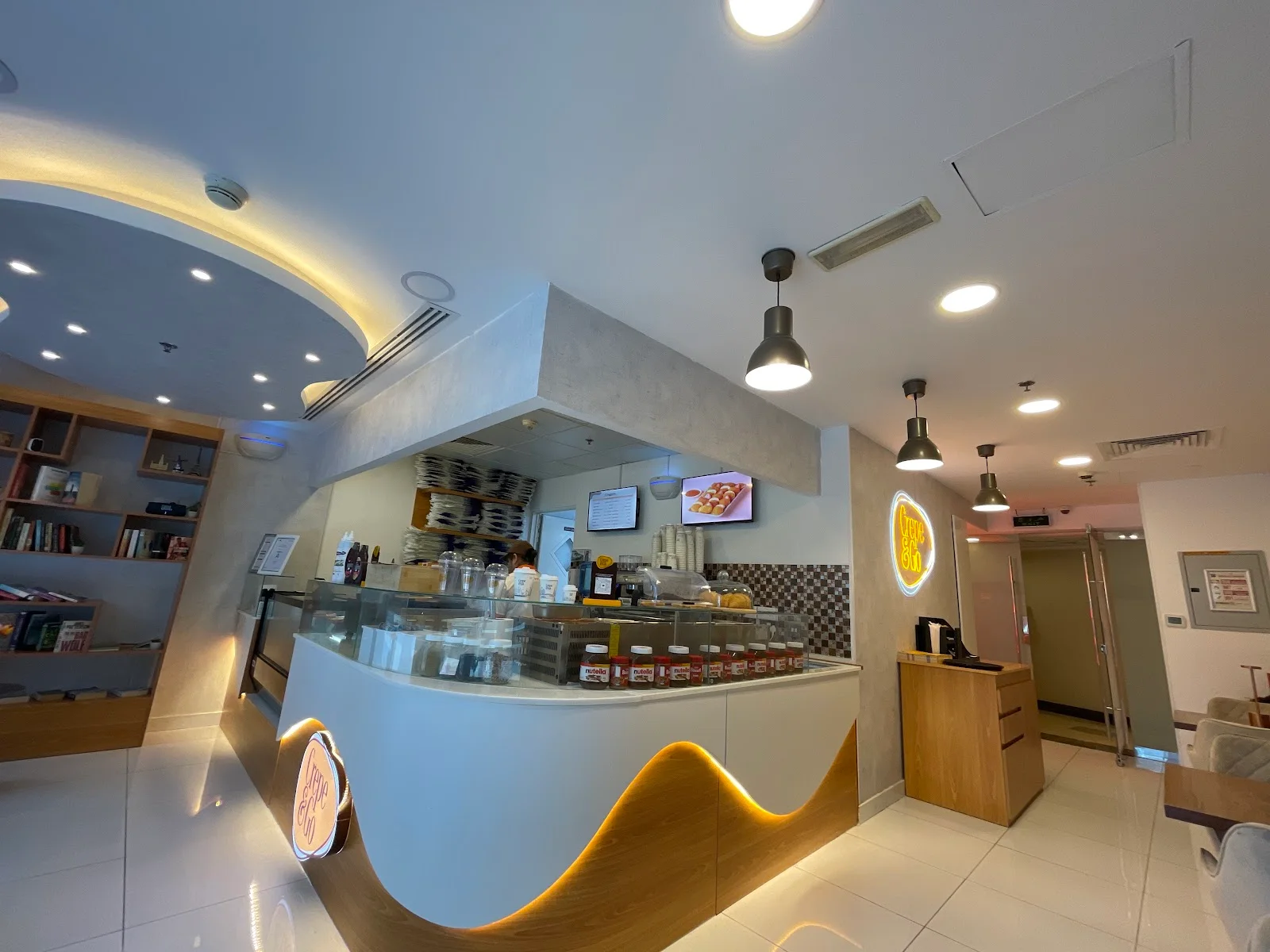 The Crepe&Go counter inside Lake Terrace Tower, JLT, with its glowing wave-front counter, plated crêpes and neon sign