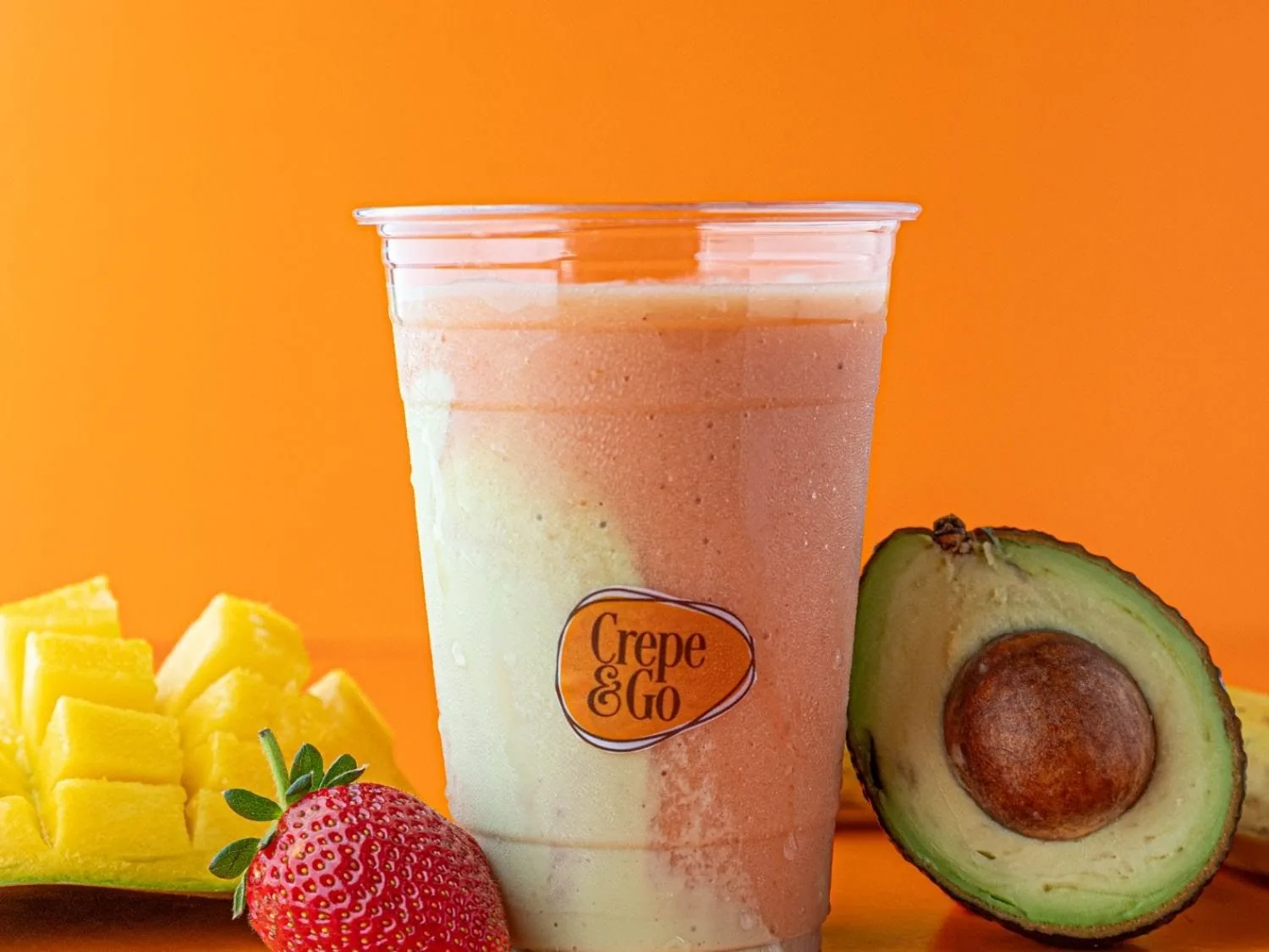 Crepe&Go fruit smoothie in a branded cup with mango and avocado