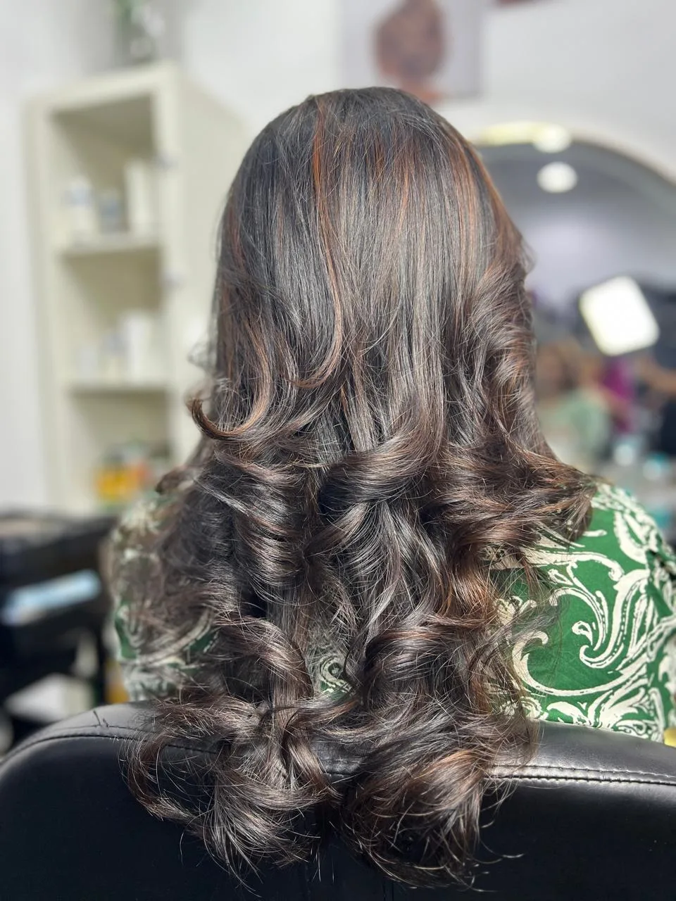 Brunette balayage curls with caramel highlights