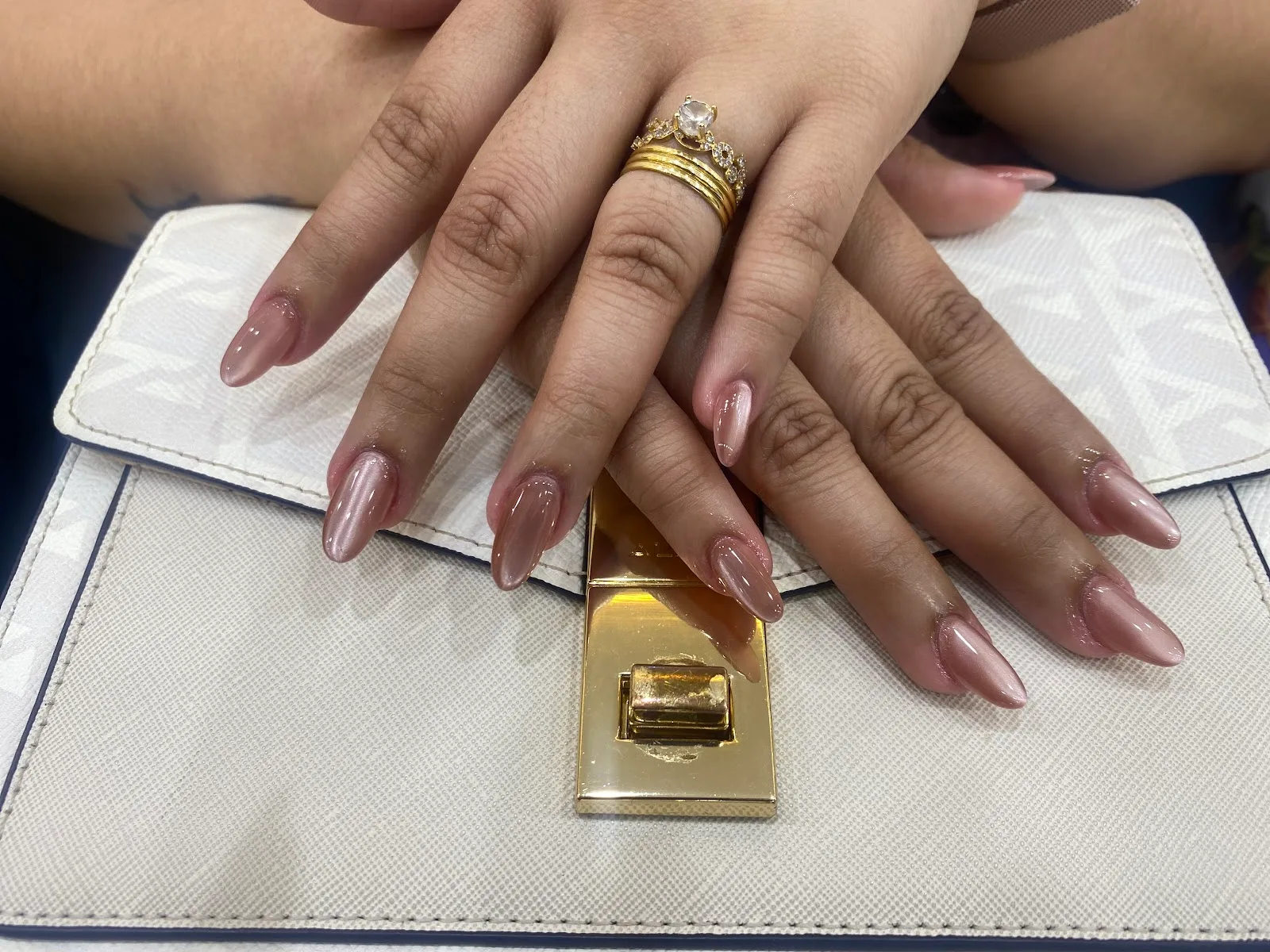 Glossy nude pink gel manicure on almond-shaped nails