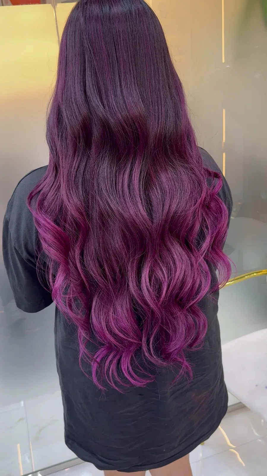 Long hair coloured in a deep violet and magenta wave
