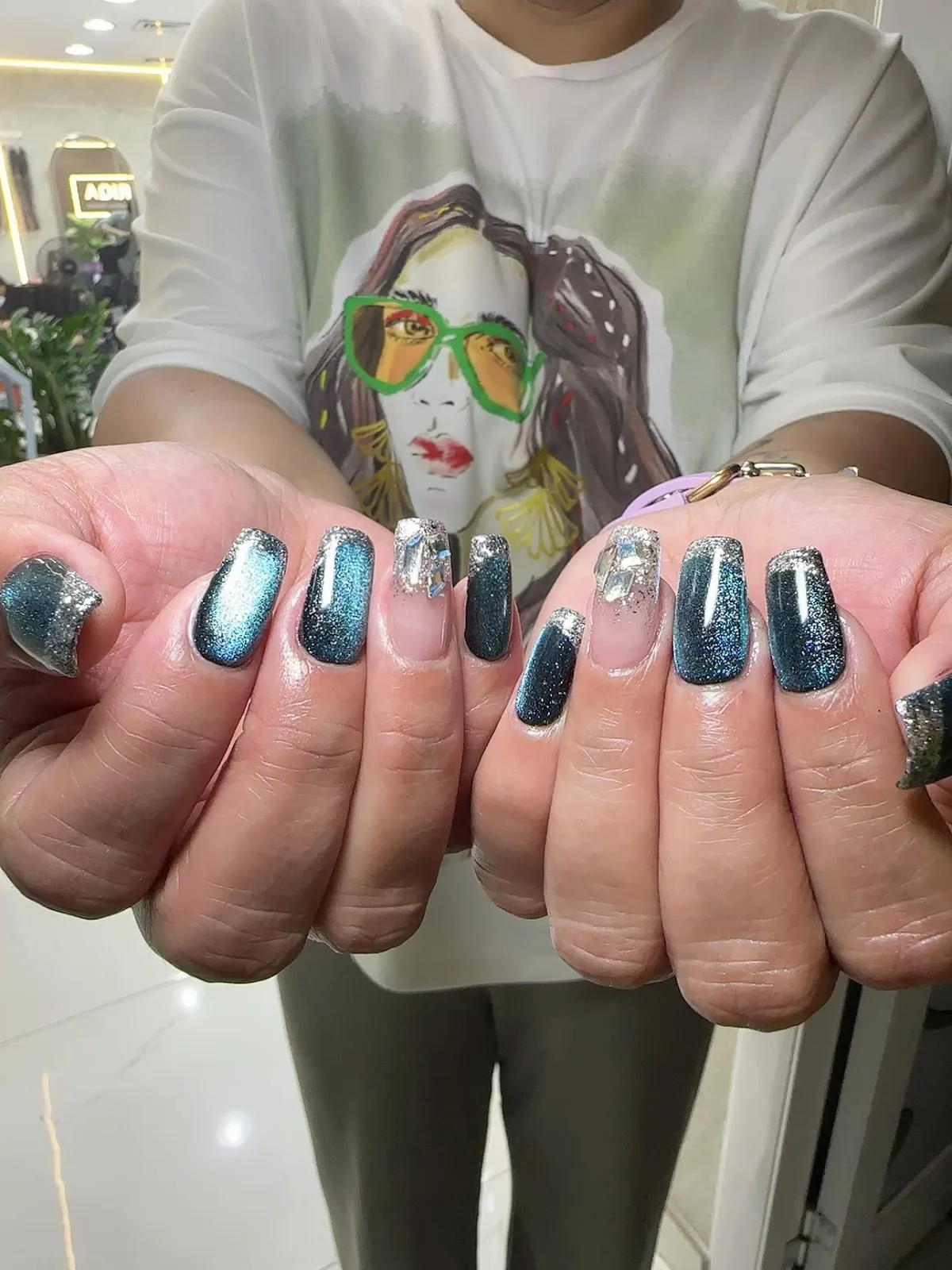 Blue chrome nails with crystal accents