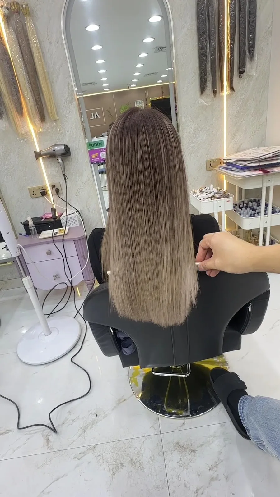 Long balayage hair styled to a glossy finish in the salon