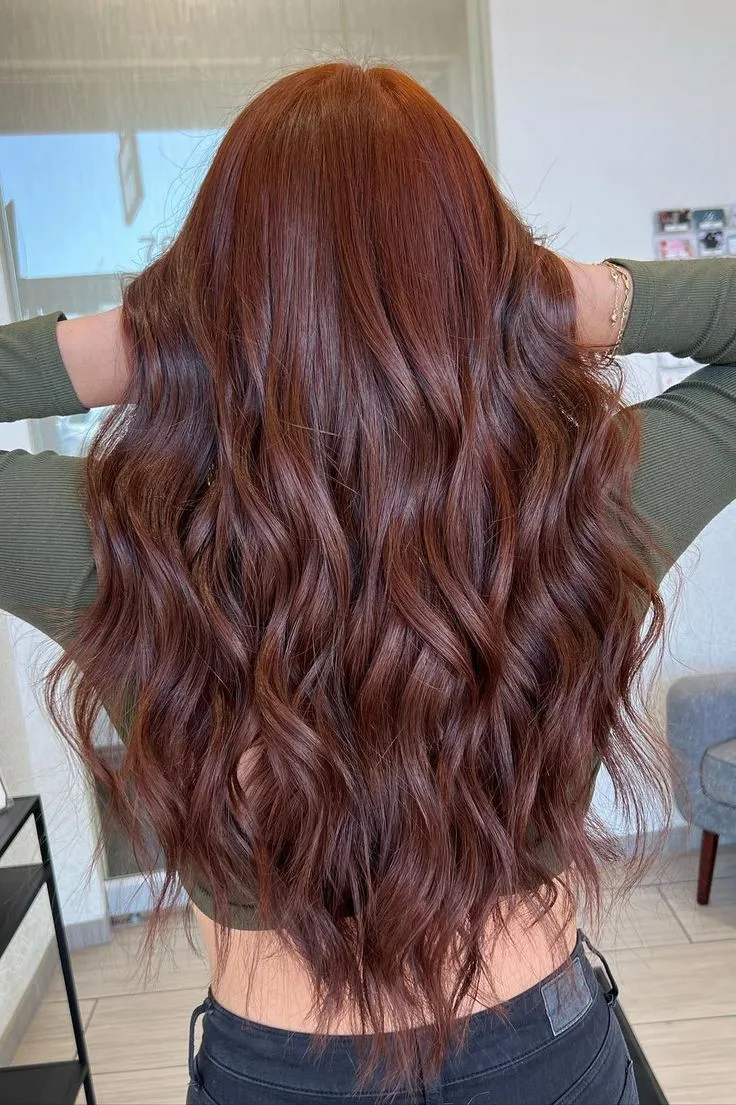 Long auburn wavy hair colour and styling result
