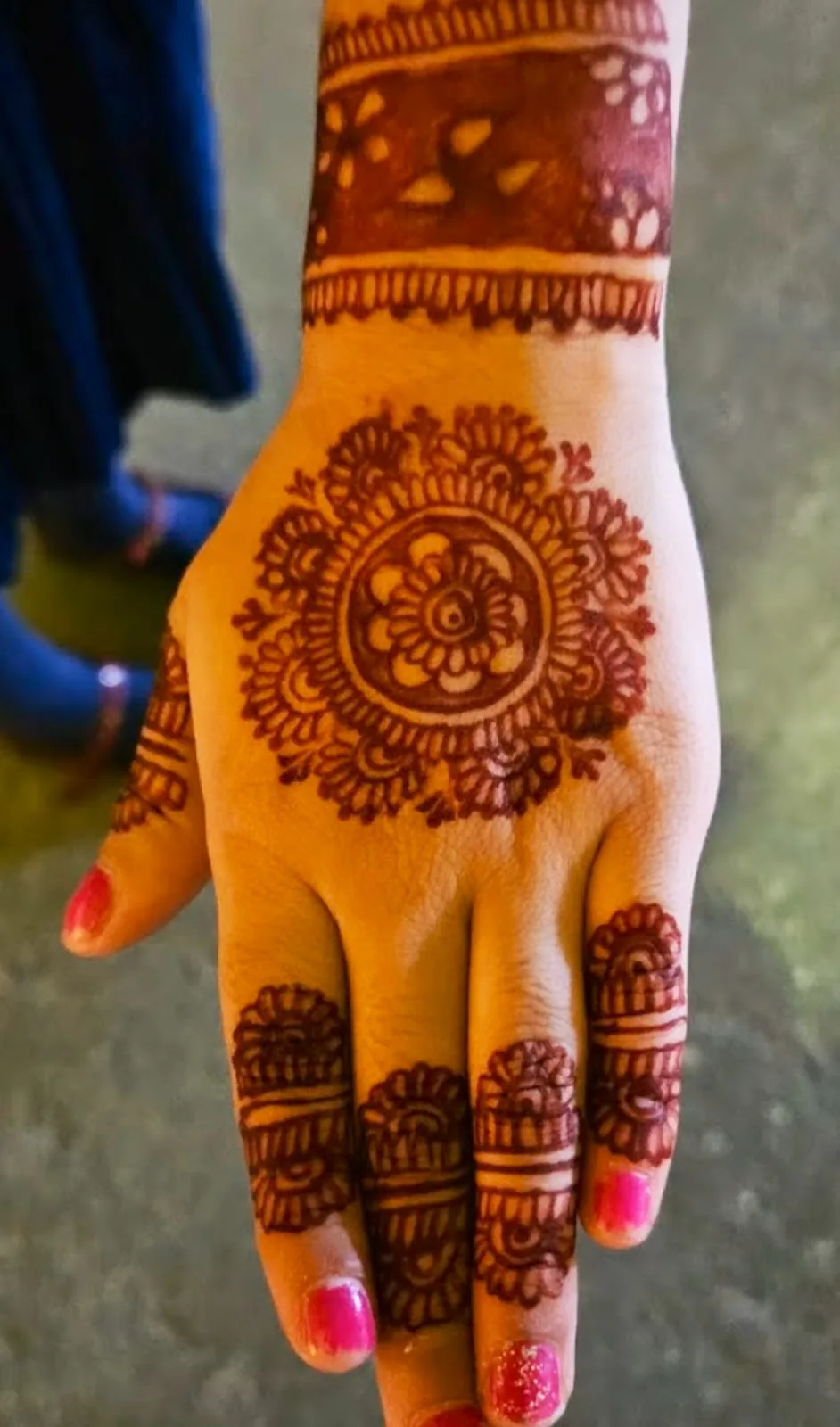 Detailed bridal henna mandala on the back of a hand