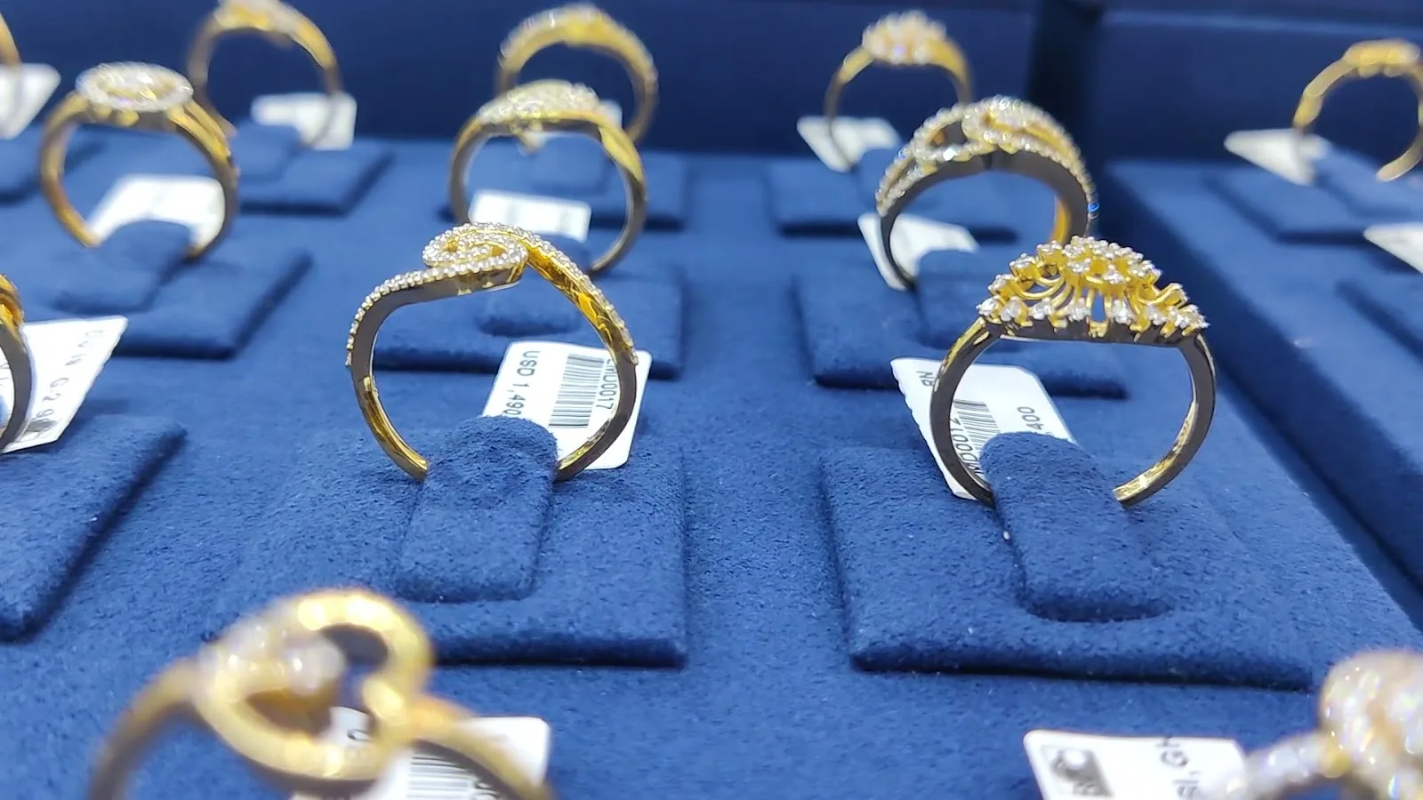 Diamond and gold rings on blue velvet