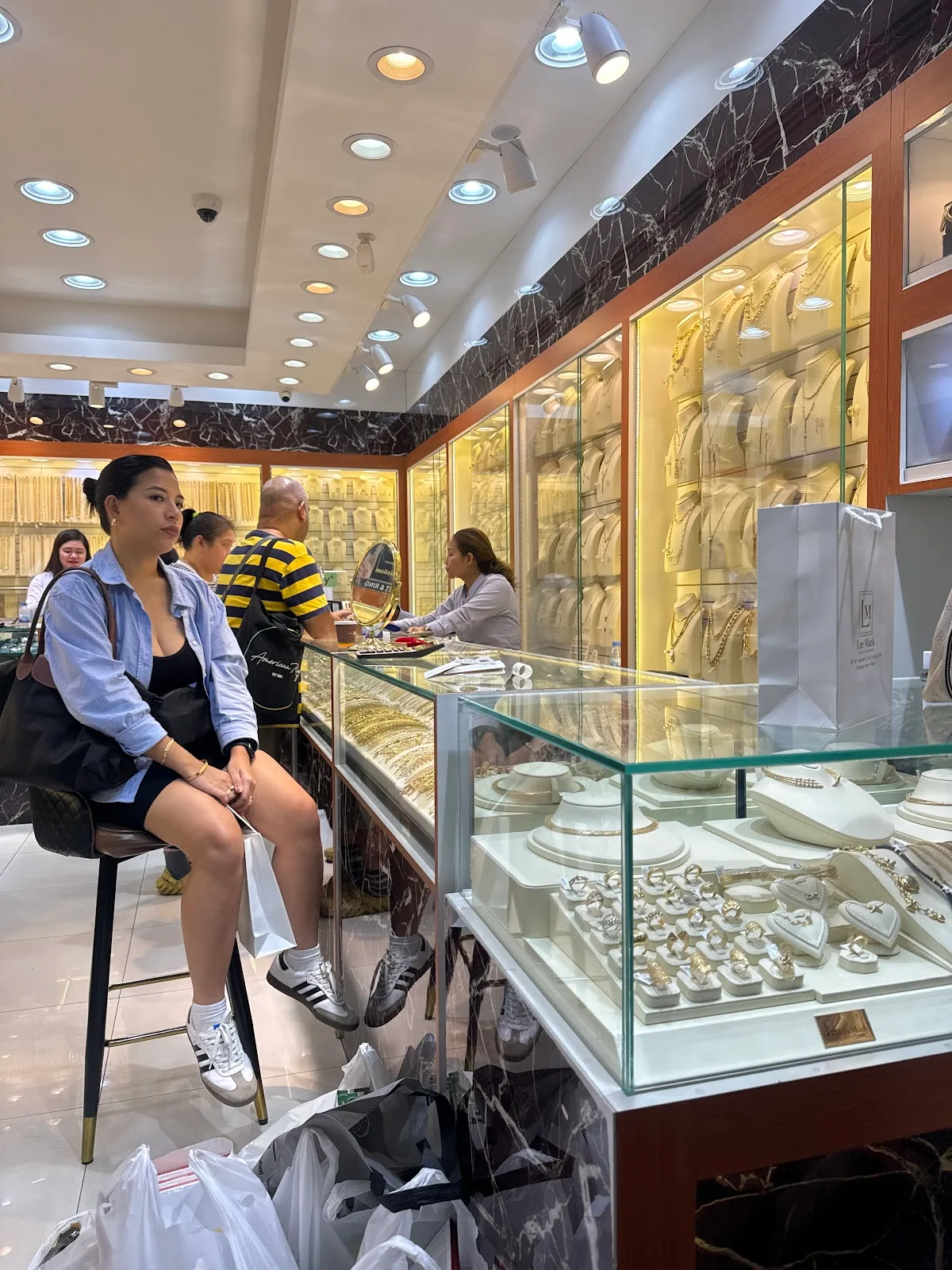 A customer seated by the display cases