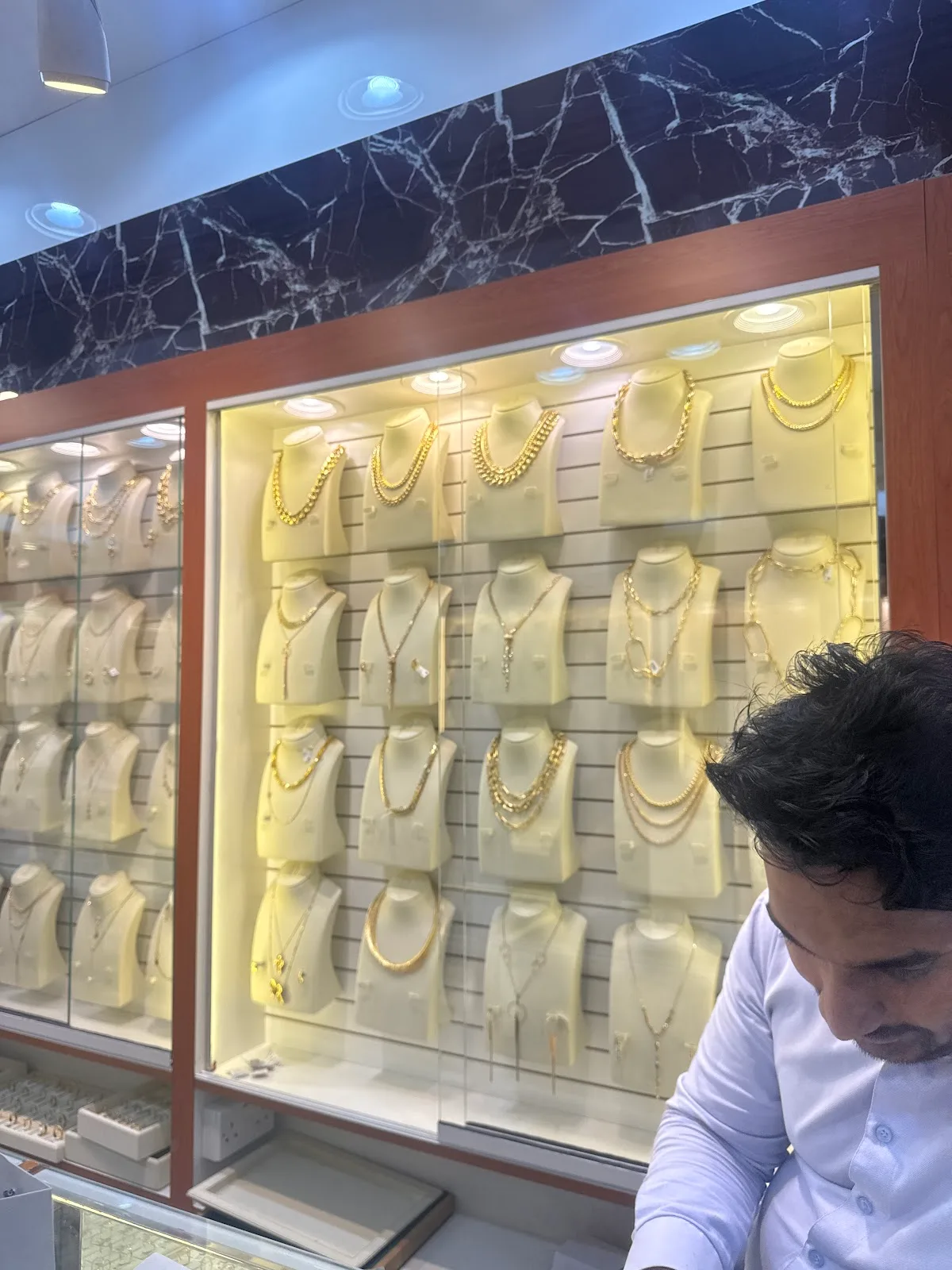 Display wall of gold chains and necklaces
