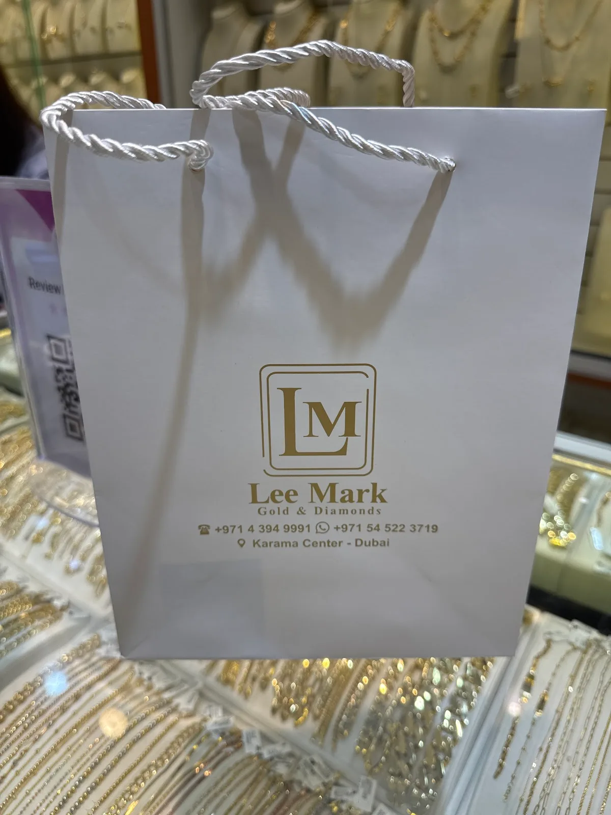 A Lee Mark Gold and Diamonds branded shopping bag
