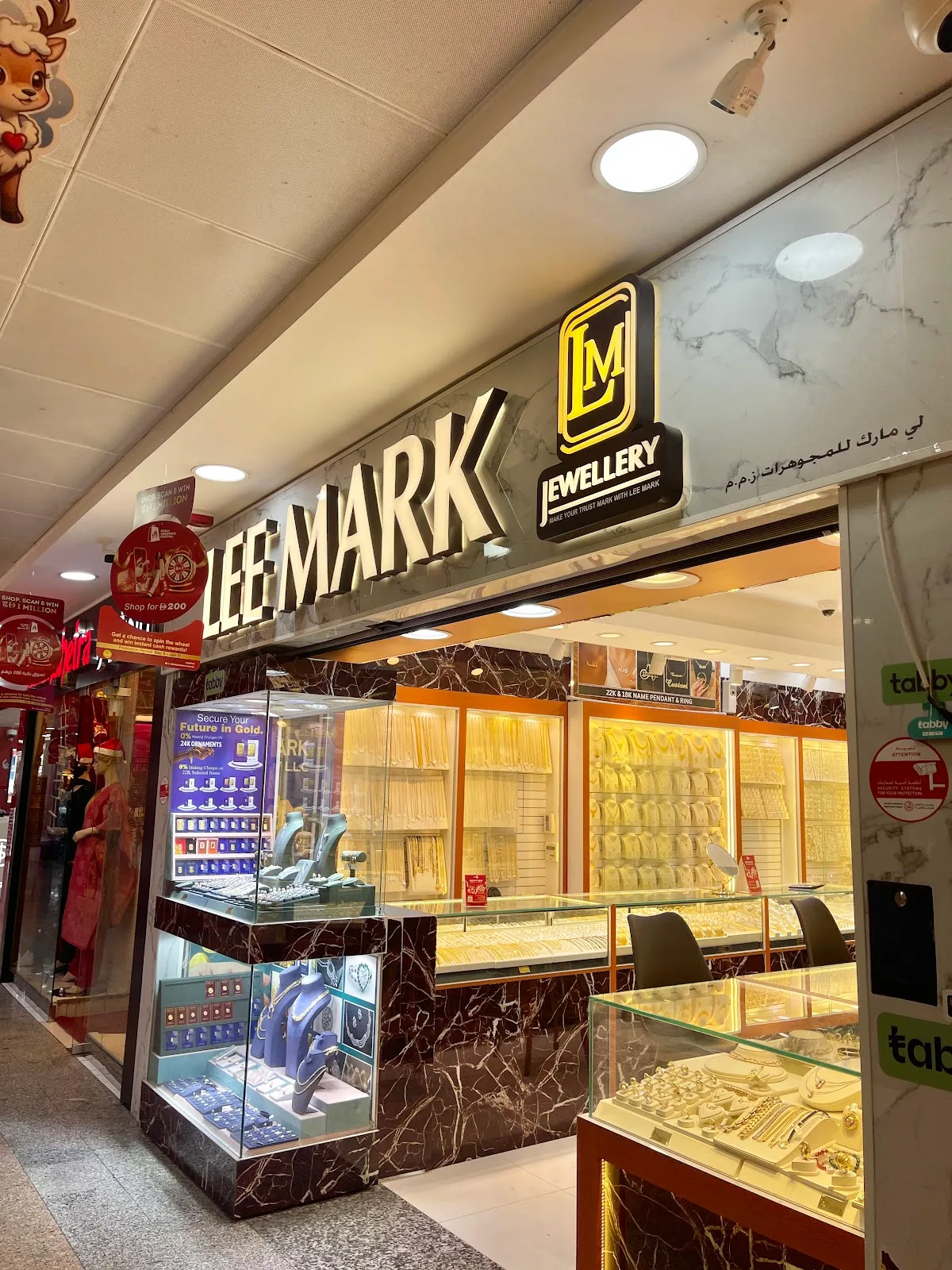 The Lee Mark Jewellery storefront and lit display windows in Karama Centre, Dubai