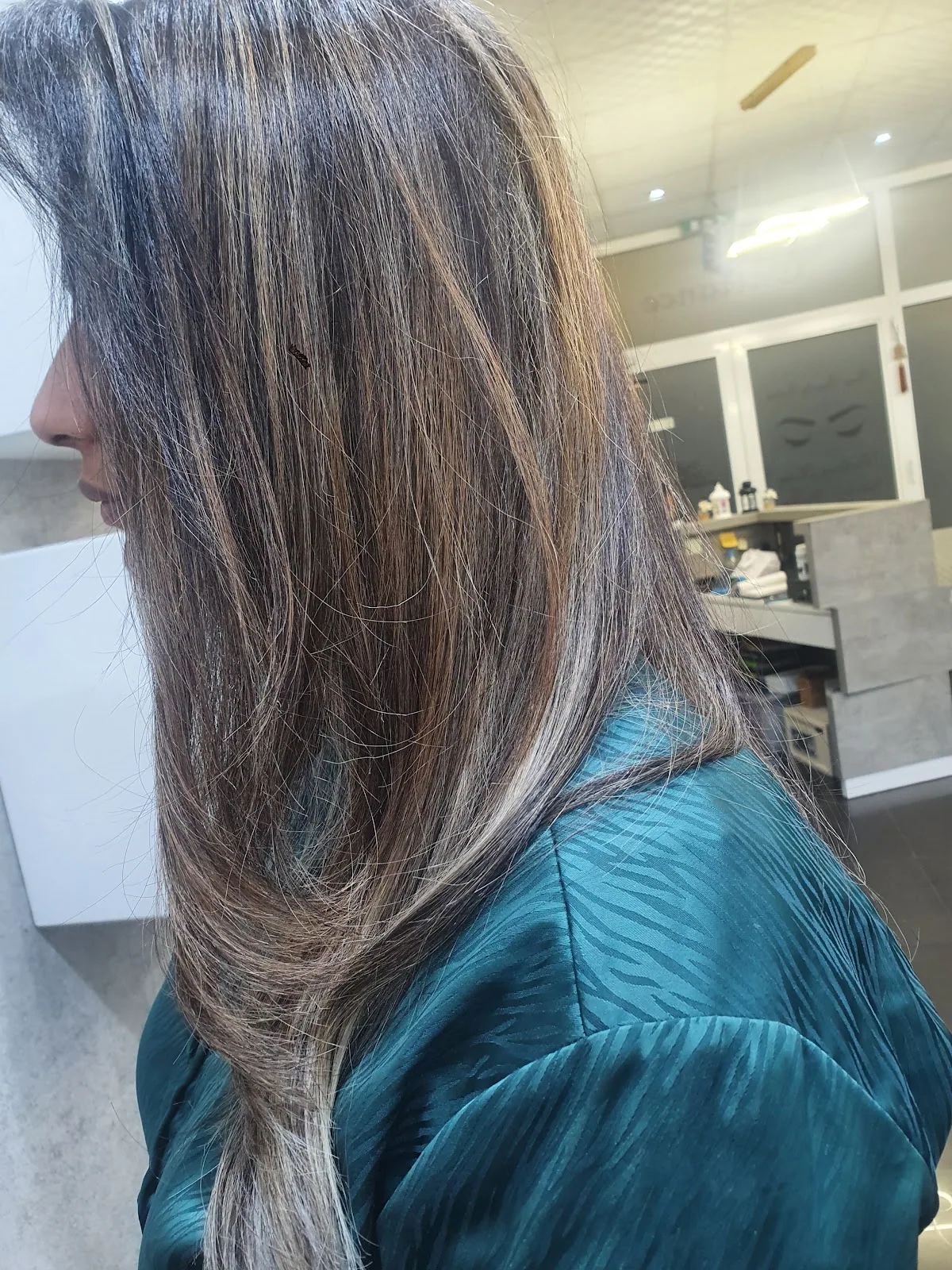Caramel balayage colour and highlights styled on long straight hair at Feya Beauty Salon
