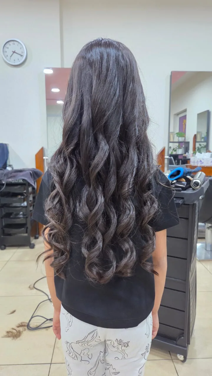 Long hair styled into glossy curls